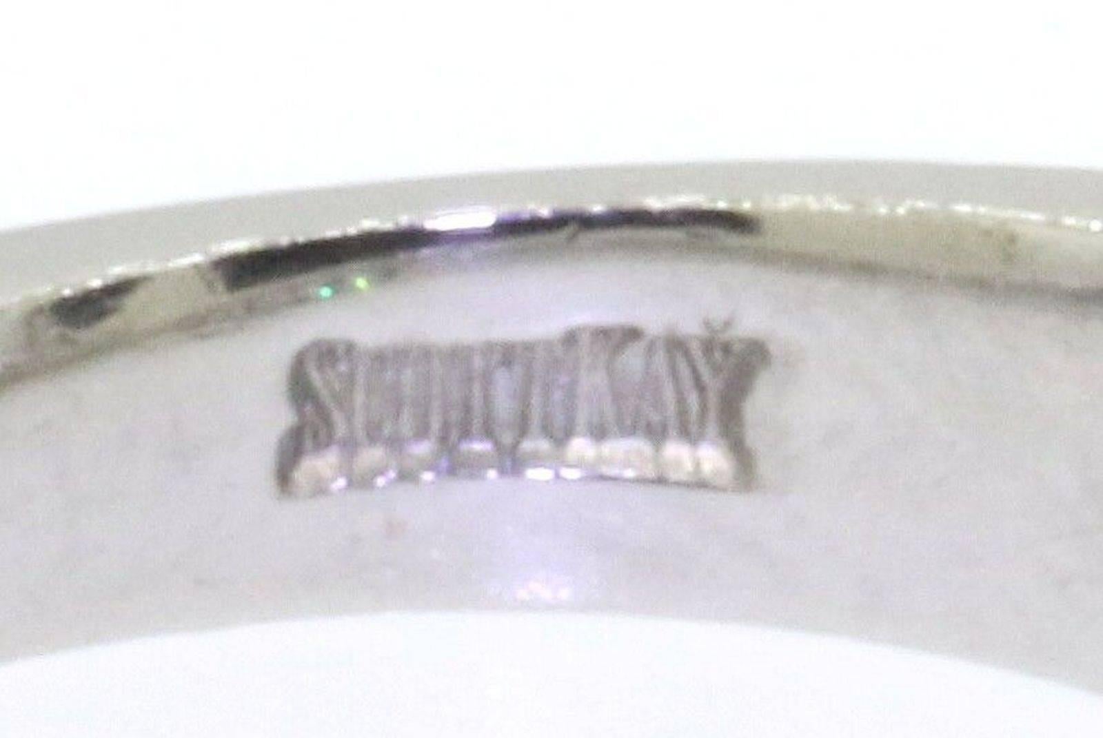 Stunning Scott Kay platinum diamond ring.  Centre diamond 1 ct F - G SI2 and side diamonds totalling 0.60 cts of F-G VS baguette cuts.    Size 6.75 and weighs 9.74 grams.  Easily re-sized.