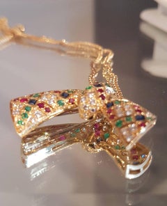 Van Cleef & Arpels Diamond, Sapphire, Ruby, Emerald Bow Pendant and Earrings