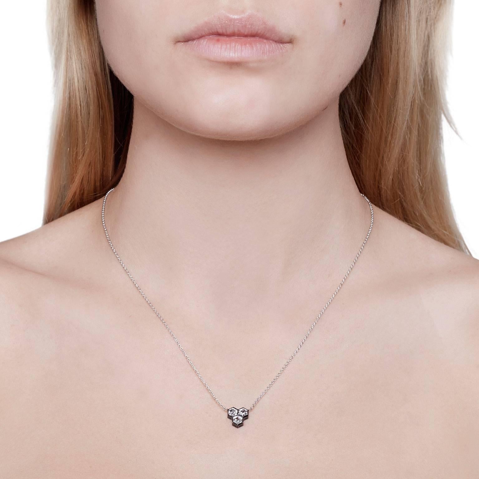 Geometric and Art Deco Style Design using rare and unique hexagon diamonds. The HONEYCOMB HEX pendant from Cushla Whiting's Celestial Collection is made in 18 carat white gold with black plating holding 3 hexagon shaped diamonds D-E VVS, total carat