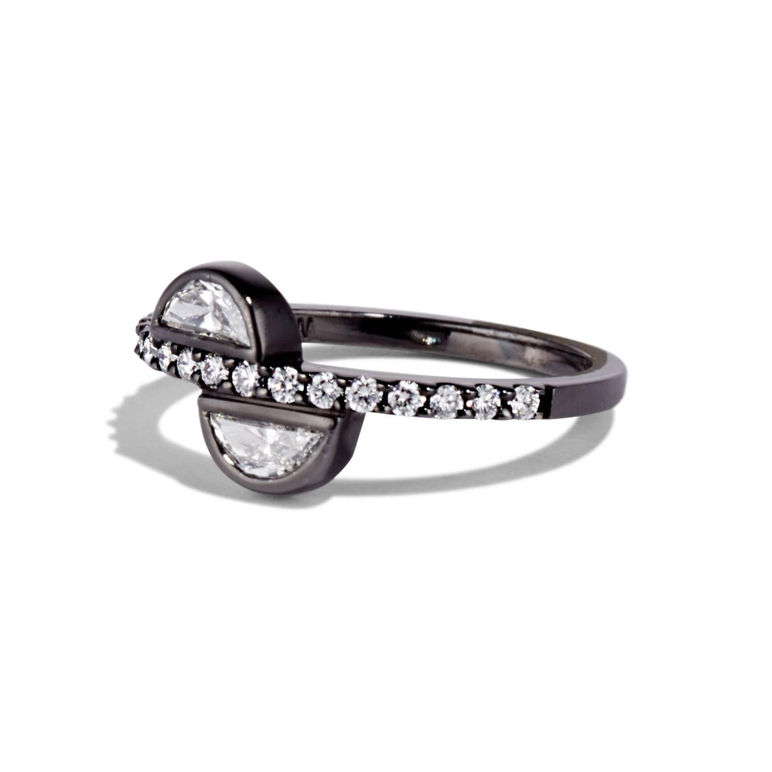 The Half Moon ring uses a pair of diamonds in a sculptural way, carving them into a geometric work of art. The HALF MOON ring from Cushla Whiting's Celestial Collection is made in 18 carat white gold with black plating holding a pair of 0.29 carat