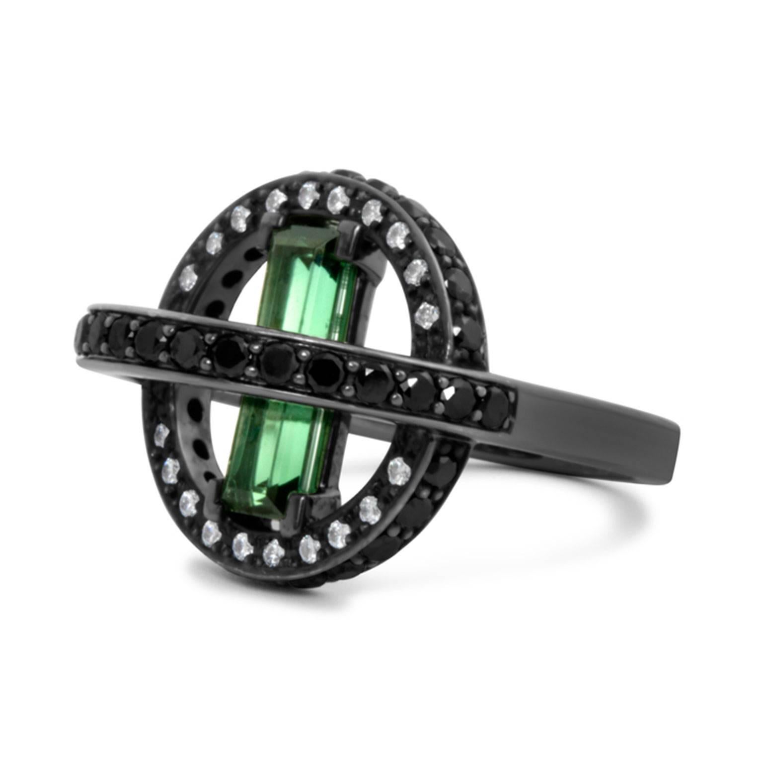 The Orbit ring is a cocktail ring to garner attention. A bold statement piece adhering to the Art Deco principle of featuring a larger stone, in this case a 1.65-carat Tourmaline, surrounded by a border of smaller black and white diamonds. Brazilian