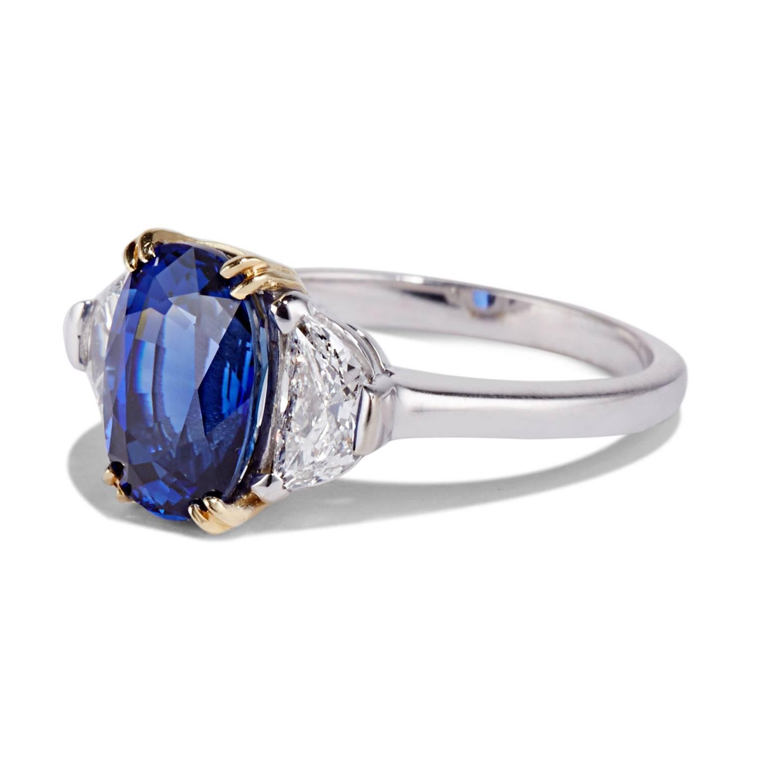 Cushla Whiting's VERONIQUE engagement ring features a striking 4.13 carat Ceylon sapphire and a pair of half moon shaped diamonds. Made in 18 karat white gold, with an 18 karat yellow gold setting, the contrast of the two metals illuminates this