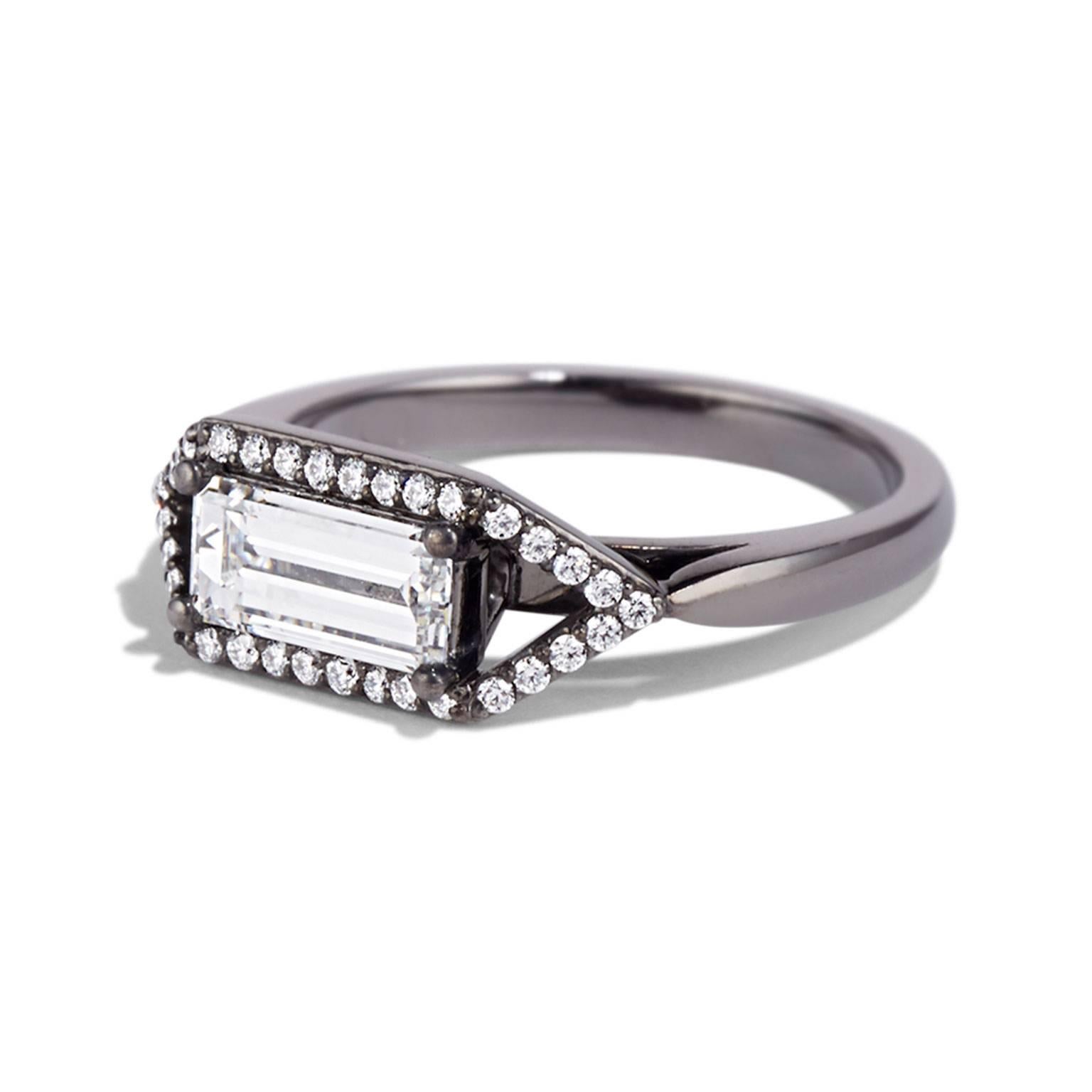 THE ZOLA RING IS A DELICATE ENGAGEMENT OPTION WHERE A CONSTELLATION OF SMALLER STONES DRAWS ATTENTION TO THE UNIQUE RECTANGULAR SHAPE OF THE CENTRAL DIAMOND. THE CONTRAST OF DIAMONDS AGAINST BLACK PLATED GOLD PROVIDES A CLASSIC ART DECO AESTHETIC.