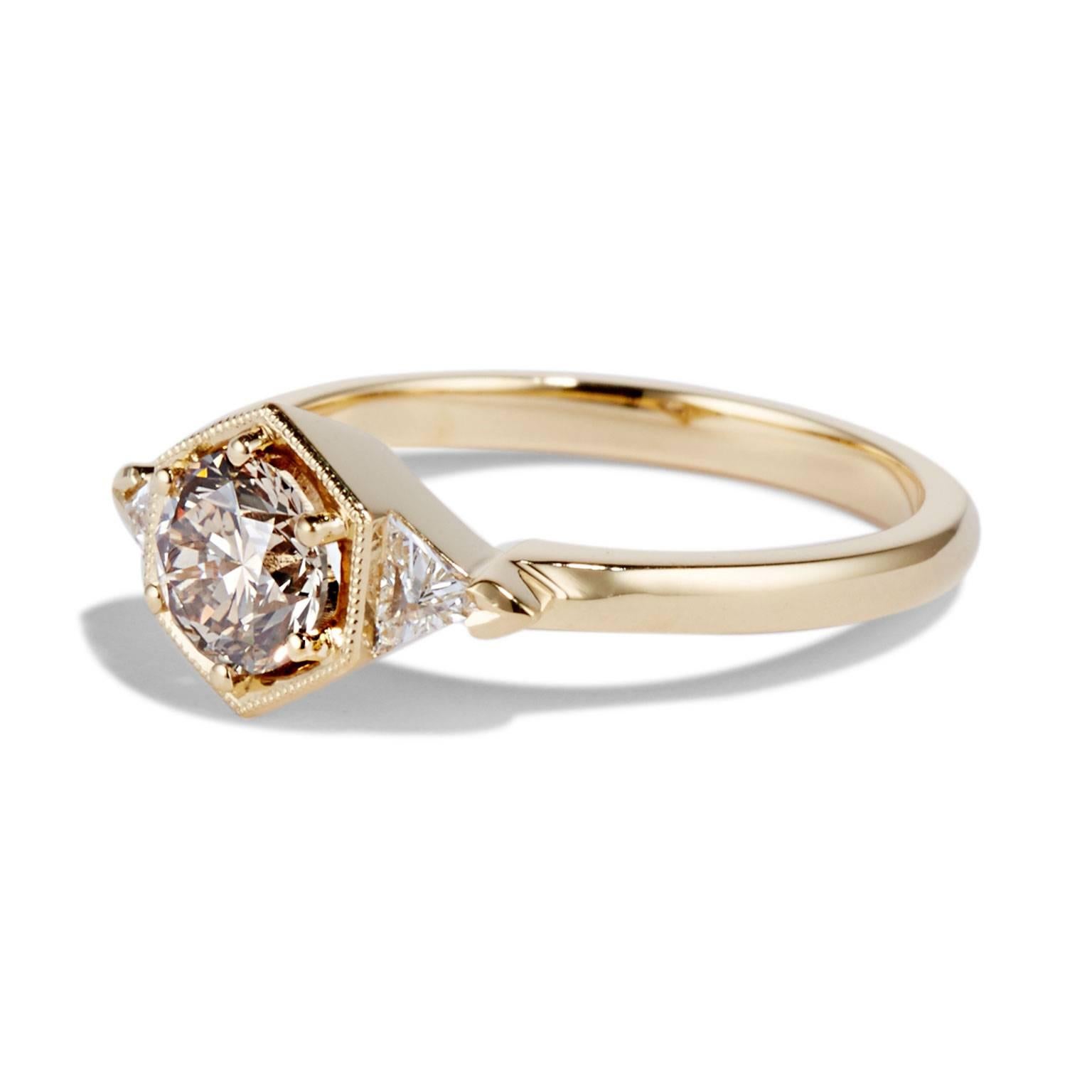 The Matilda ring fused modern stones with an antique aesthetic in an ultra-feminine style. A 0.80 carat diamond sits inside and 18-karat gold hexagonal setting, accompanied by two triangle shaped diamonds either side.

Image shows the MATILDA ring