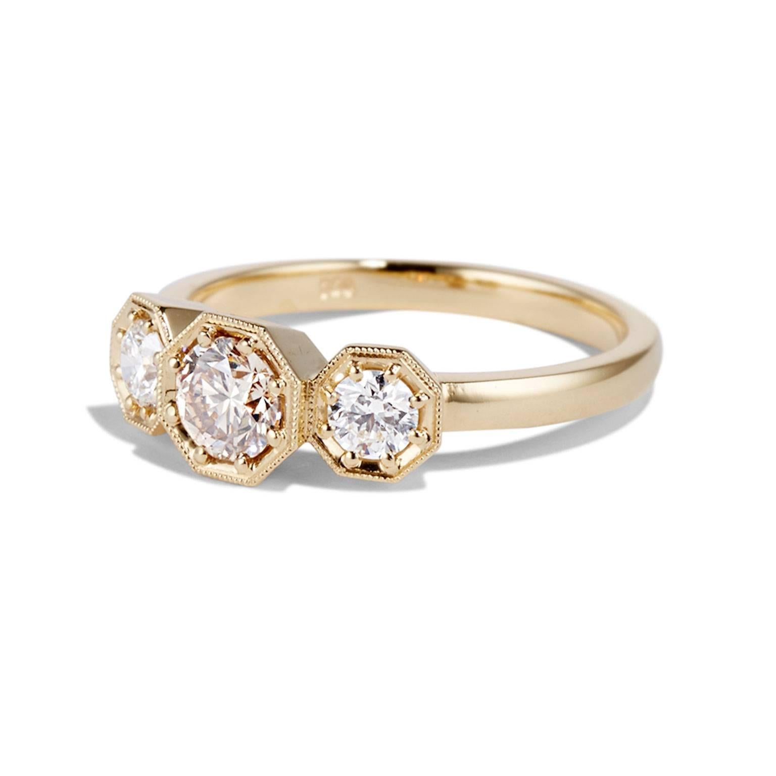 Featuring three diamonds, the Cushla Whiting's Clara ring is a pretty take on the classic triple stone engagement style. A trio of round stones sparkle in a gold, hexagonal setting.

The CLARA ring is made in 18 karat gold holding a 0.50 carat