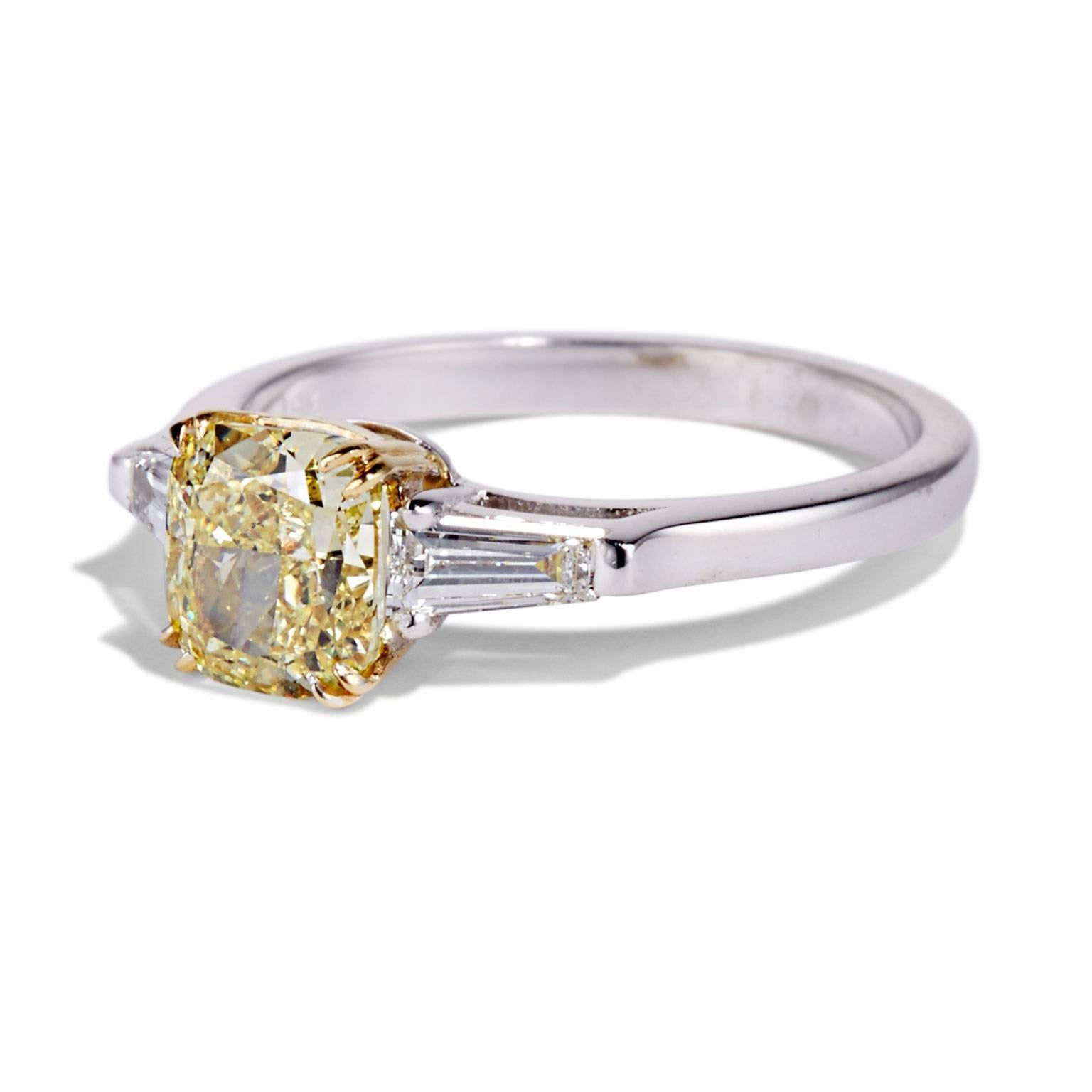 This intense yellow cushion cut diamond is flanked by two perfectly balanced tapered baguettes, angled precisely to follow the profile of the finger.
The BARBARA ring incorporates a mixture of metals with yellow gold sharp, split claw prongs