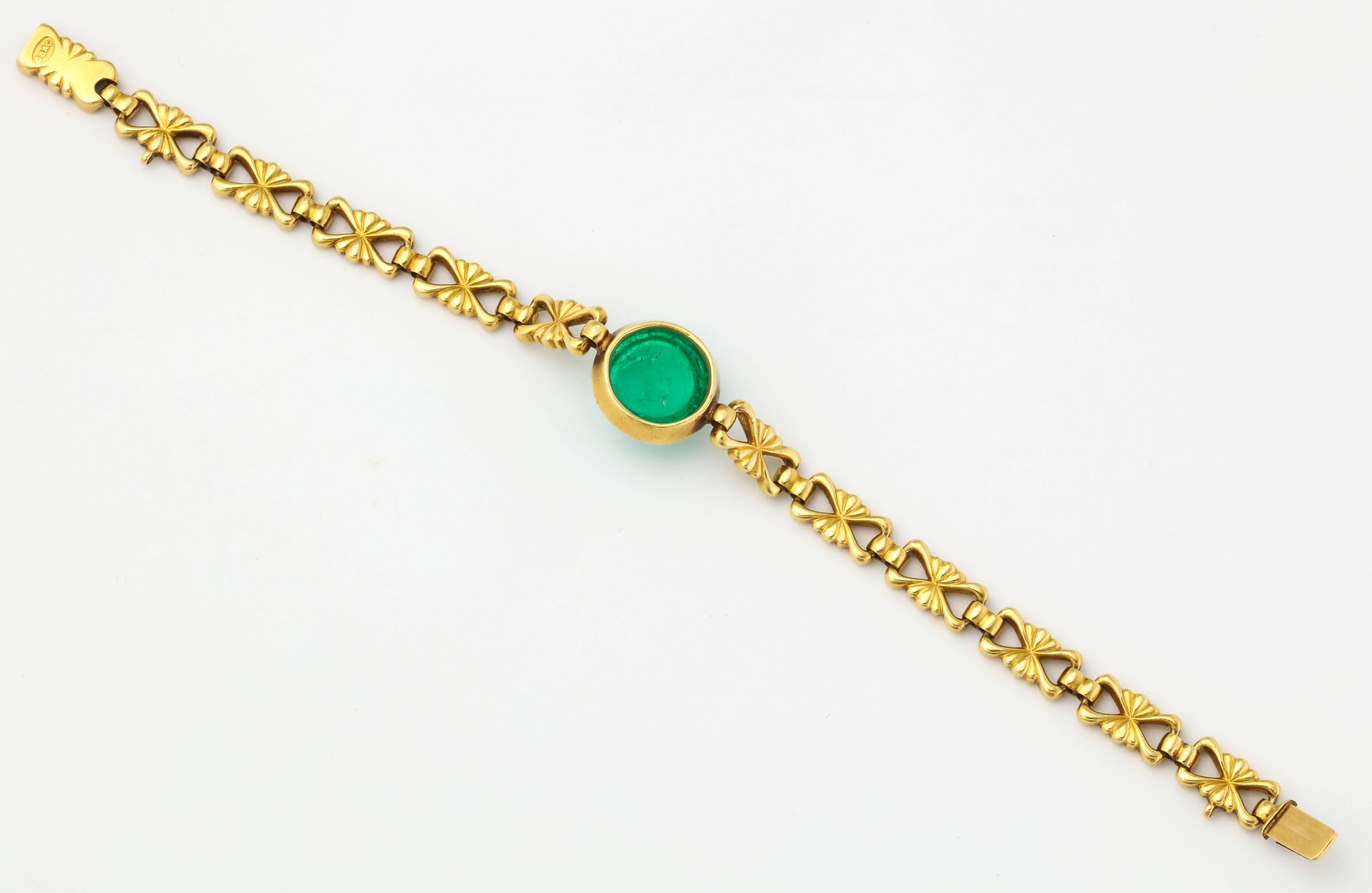 Cabochon Emerald Bracelet by Carlo Giuliano 

Center emerald approx 10 ct

Giuliano Makers Mark - C&AG

18 Karat Gold

Made in Italy Circa 1900