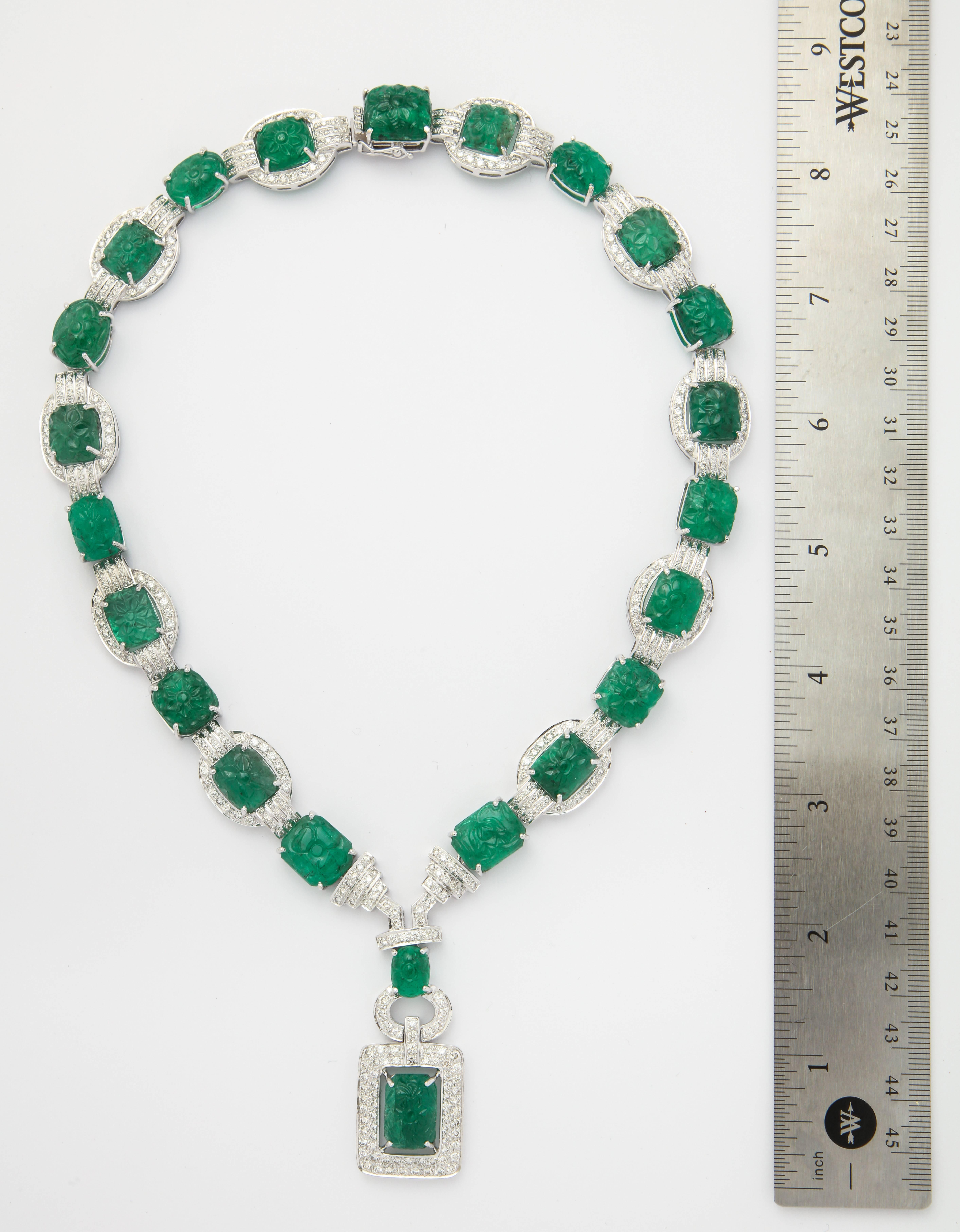 A very rare collection of matching carved emeralds set in a beautiful diamond necklace.

