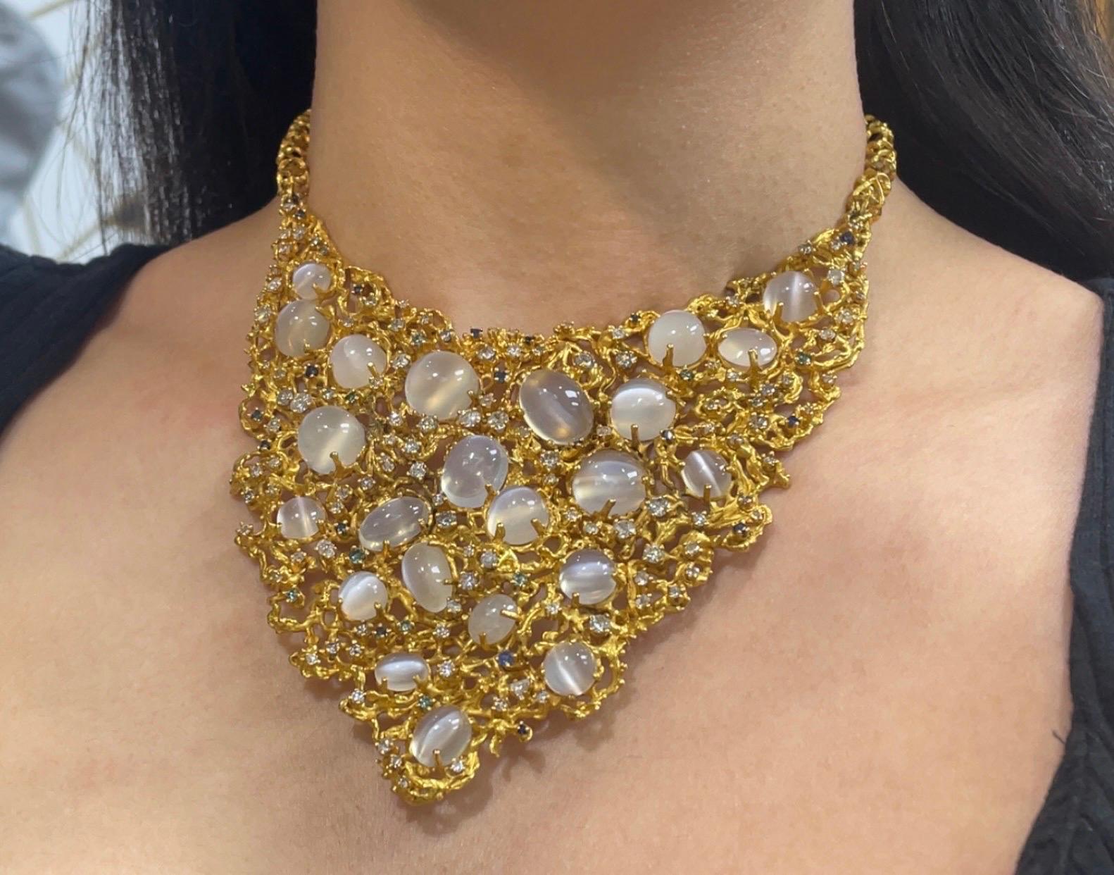 Mondstein-Lätzchen-Halskette

Ein großes brutalistisches Gelbgold-Latzcollier, besetzt mit 22 Cabochon-Mondsteinen, akzentuiert mit runden grünen Diamanten, Saphiren und weißen Diamanten im Mischschliff.

Ungefähre kombinierte Gewichte: 
Mondstein: