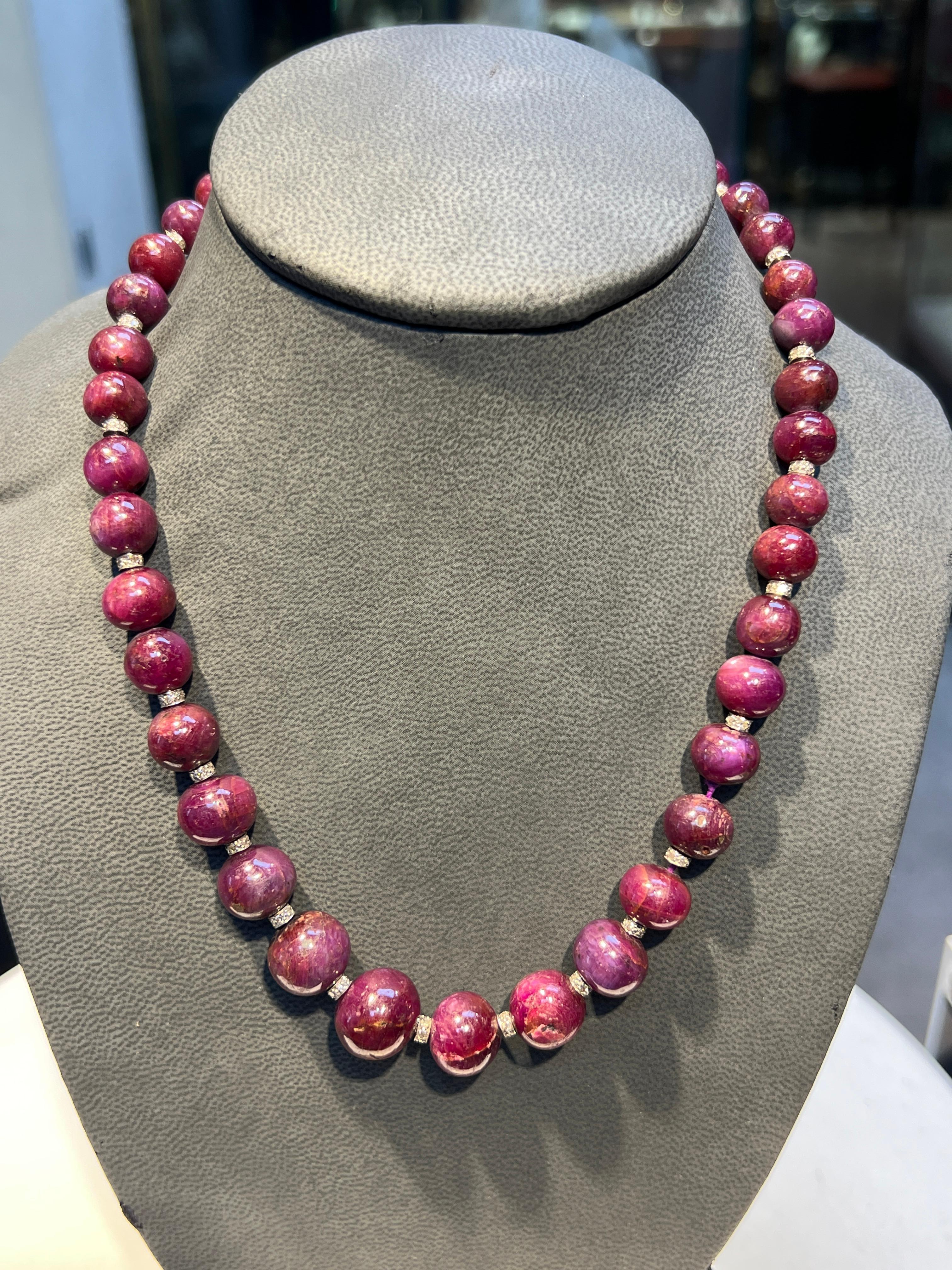 Ruby Bead Necklace 

A strand neck with 39 ruby beads spaced by 22 diamond spacers and a marquise shaped clasp set with round-cut diamonds

Approximate Ruby Weight: 393.26 carats
Approximate Diamond Weight: 2.50 carats
Approximate Length: 17