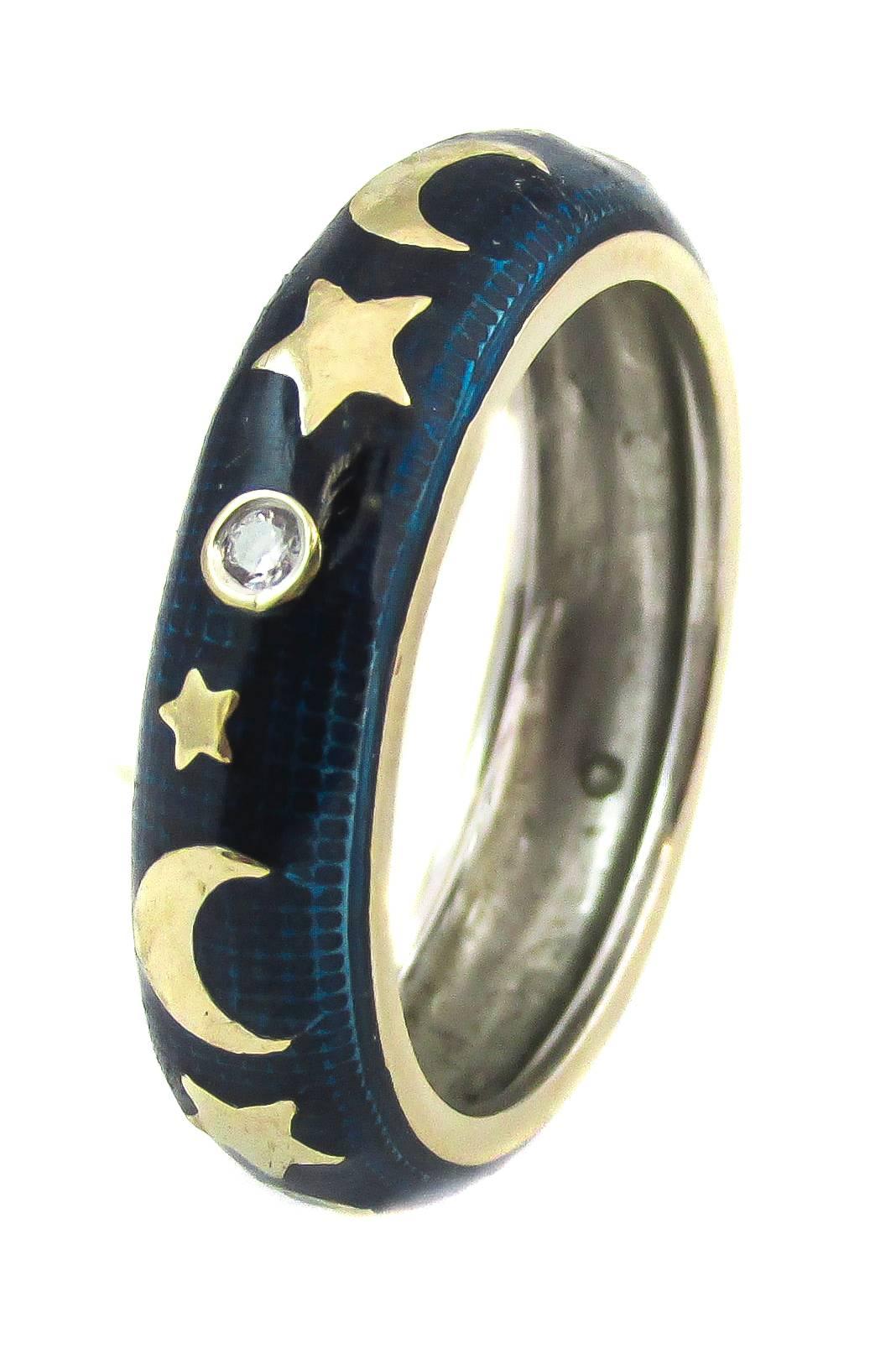 Stamped Hidalgo, this finely crafted blue enamel band brings the sky, moon and stars to you. Yellow gold stars and moons alternate with a diamond, set in a tiny, yellow gold bezel .

-	Size 6.5
-	Stamped Hidalgo, 750
-	5.5 grams
-	3.6 dwt
