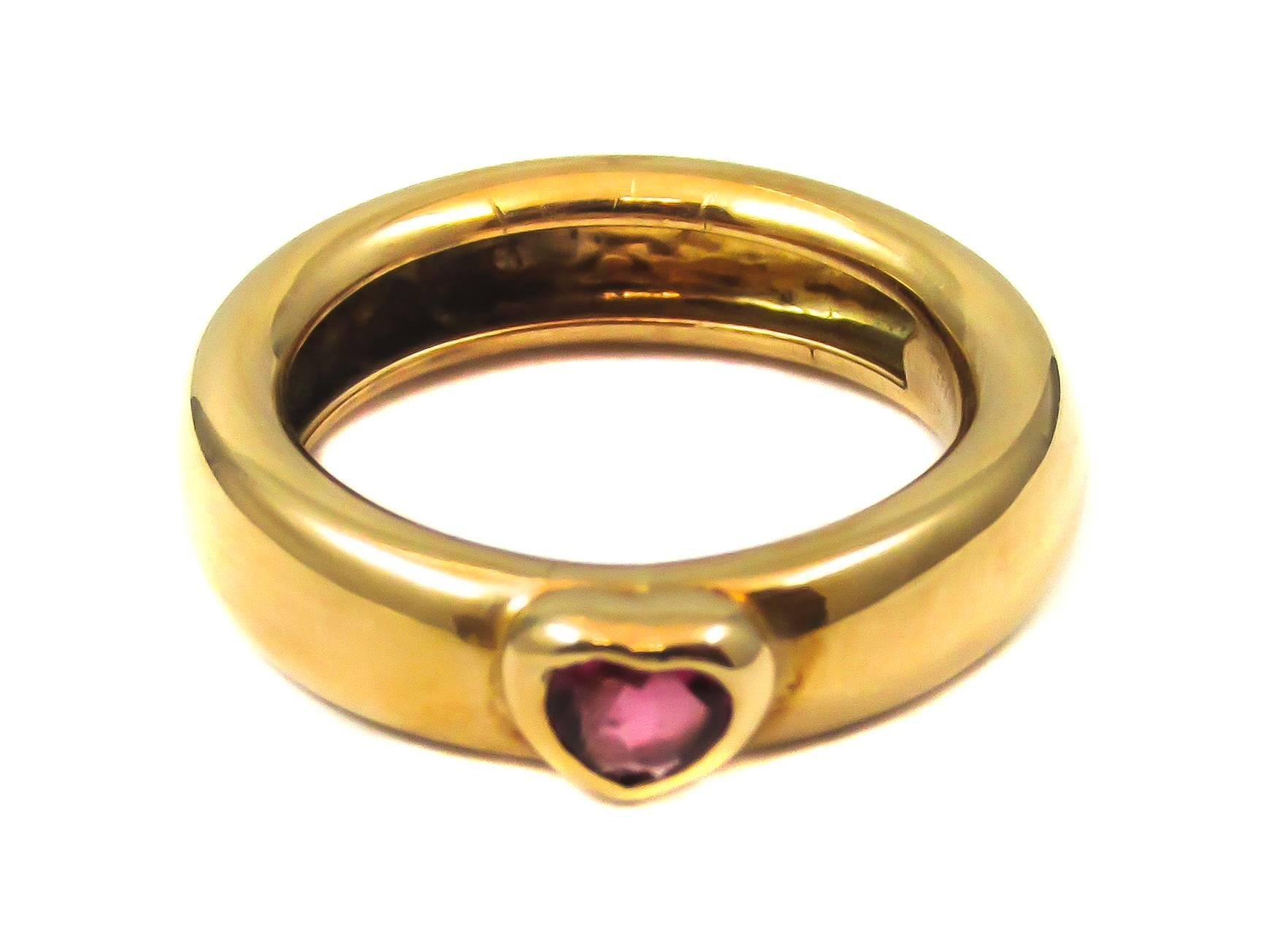 Tiffany & Co. yellow gold band ring features a heart shaped Ruby in a gold heart shaped bezel setting. What could be more romantic as a ruby red token of your heart’s love? Tiffany has always understood the symbolic attraction that jewelry can