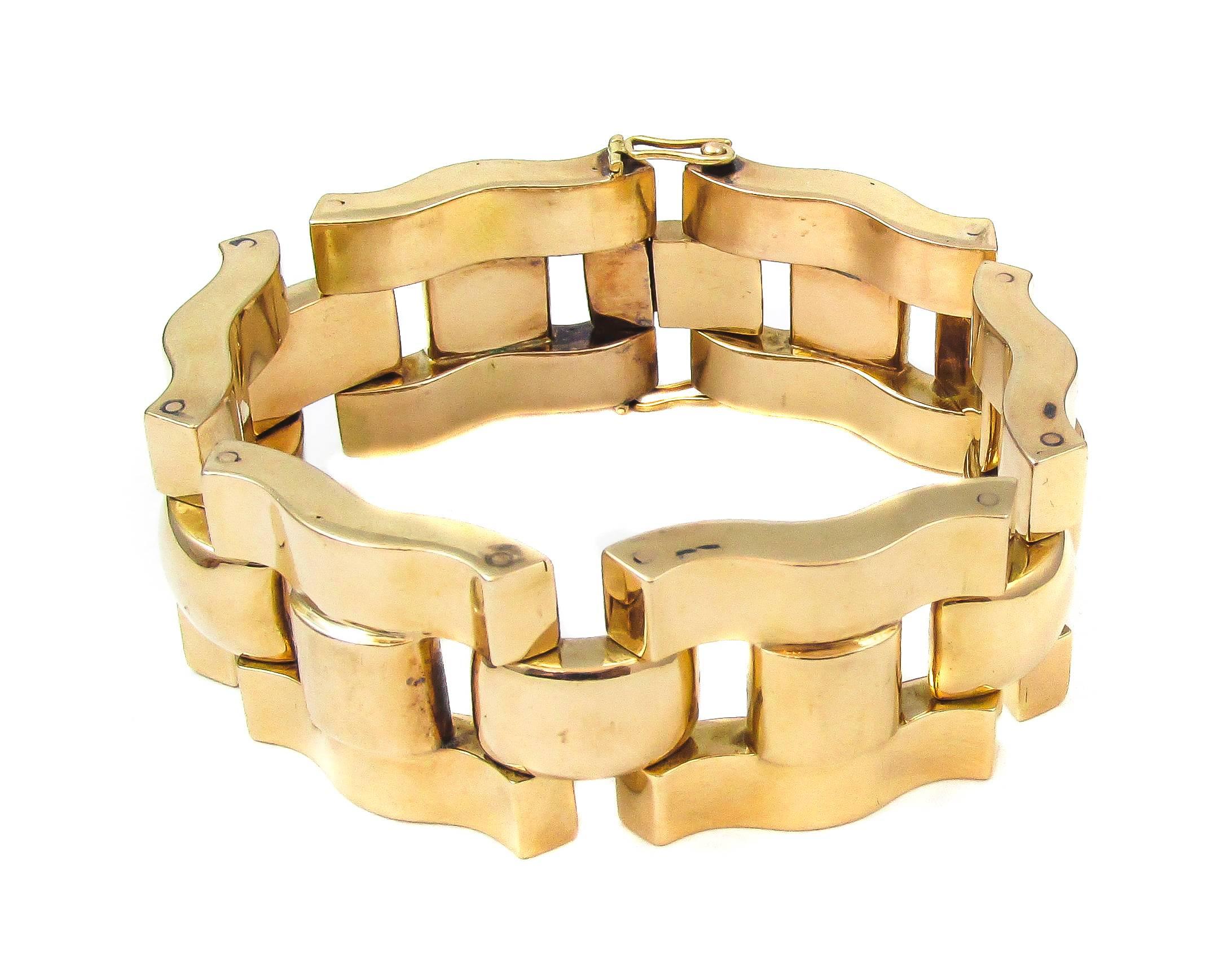A beautiful and substantial 18K yellow gold retro link bracelet. Solidly swirled geometrical links make for smooth movement on the wrist, displaying the boldly detailed, curved and rounded elements. French jewelers were always known and favored for