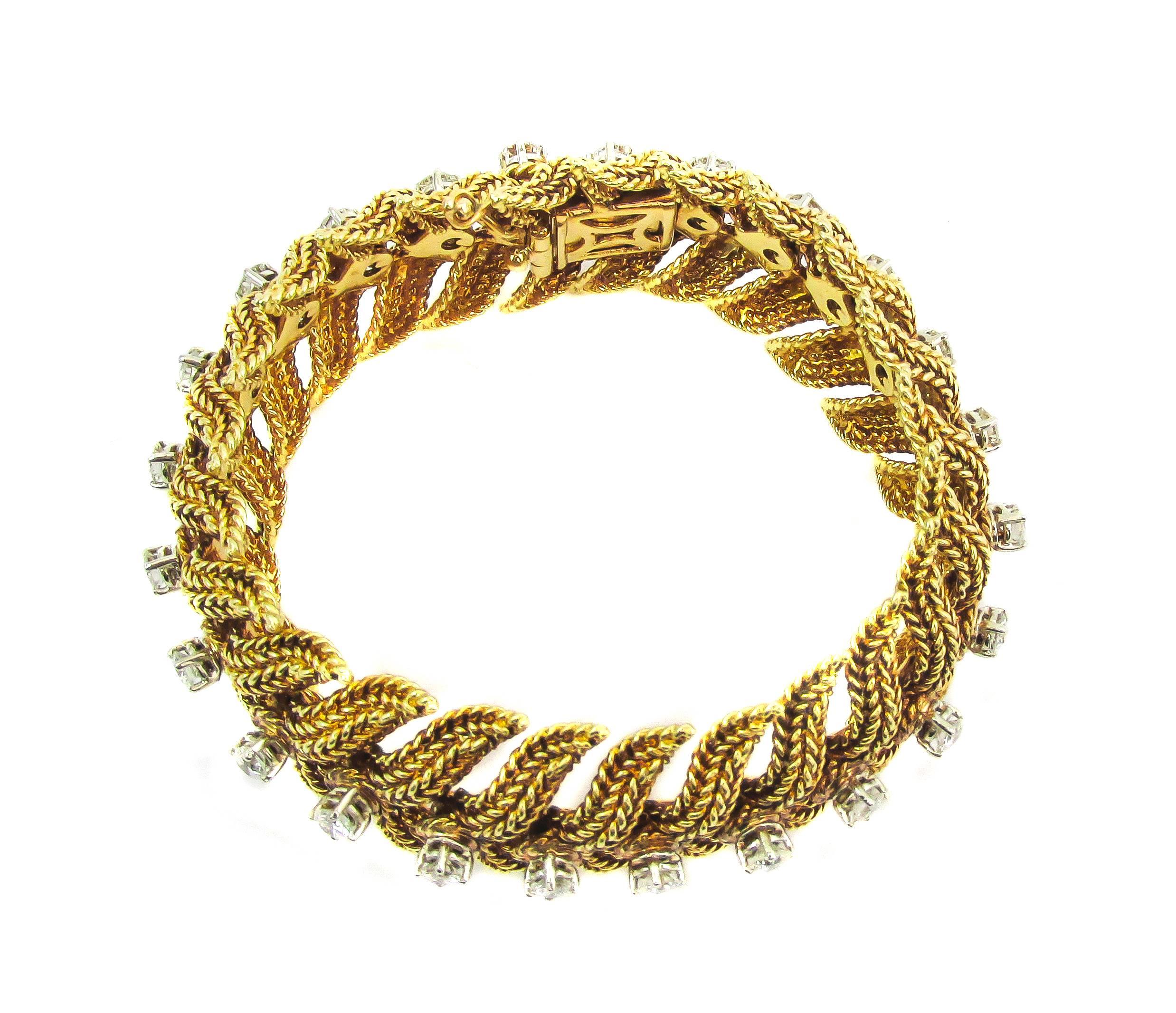 Elegant 1970’s Tiffany & Co. gold and diamond flexible link bracelet constructed out of braided gold wires. The beautifully hand crafted elements, which flow out from the centrally set round brilliant cut diamonds, resemble flowing leaves which move