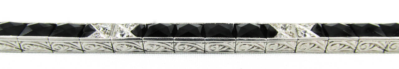 This elegant Art Deco platinum diamond and onyx bracelet features the classic 