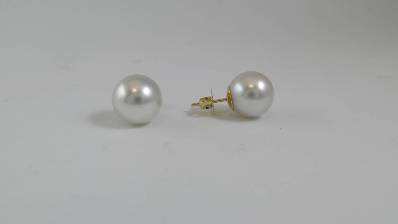Amazing pair of 12.2 millimeter South Sea cultured pearl earrings. The pearls are extremely white and bright giving them a unique glowing appearance on the ear. The thick nacre, which is a caliber for the high quality of the pearls, give them their