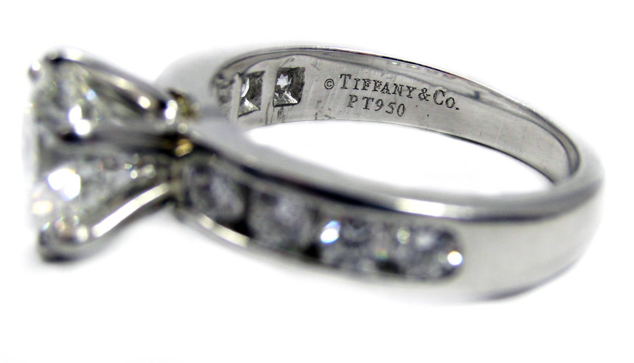 Tiffany platinum, diamond solitaire, center diamond 2.13 ct., GIA certified, color: G, clarity: VS 1,  8 side round brilliant cut diamonds weighing approx. 0.80 cts. total, size 7, sizable, signed Tiffany & Co. PT950, numbered 26190576, in Tiffany &