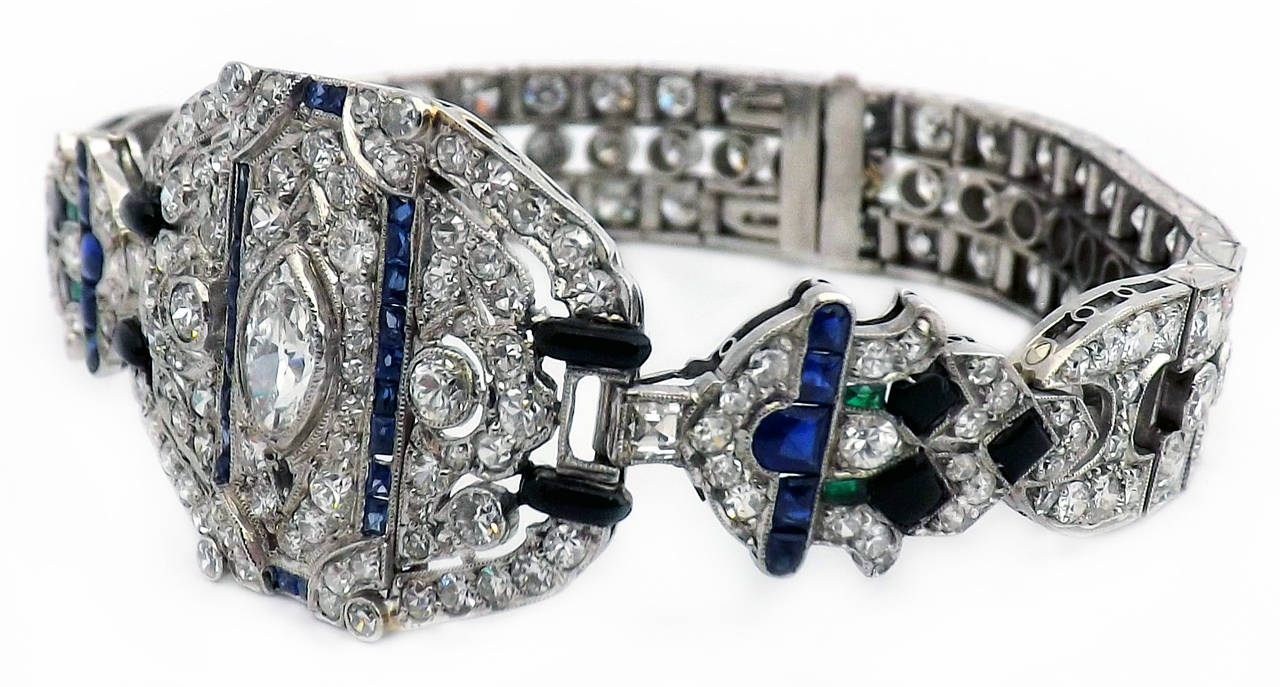 Art Deco platinum,  diamond, buff top, emerald, sapphire, black onyx bracelet, 211 round brilliant cut diamonds, 4 emeralds, 32 sapphire