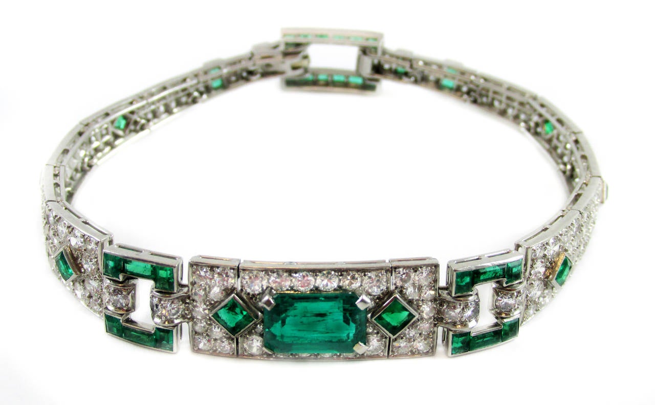 Cartier Art Deco platinum diamond emerald bracelet, center emerald weighing approx. 2.4 cts, further set with 40 square and rectangle shaped emeralds, surrounded by 168 Old European cut diamonds weighing approx. 5.5 cts, signed Cartier and numbers,