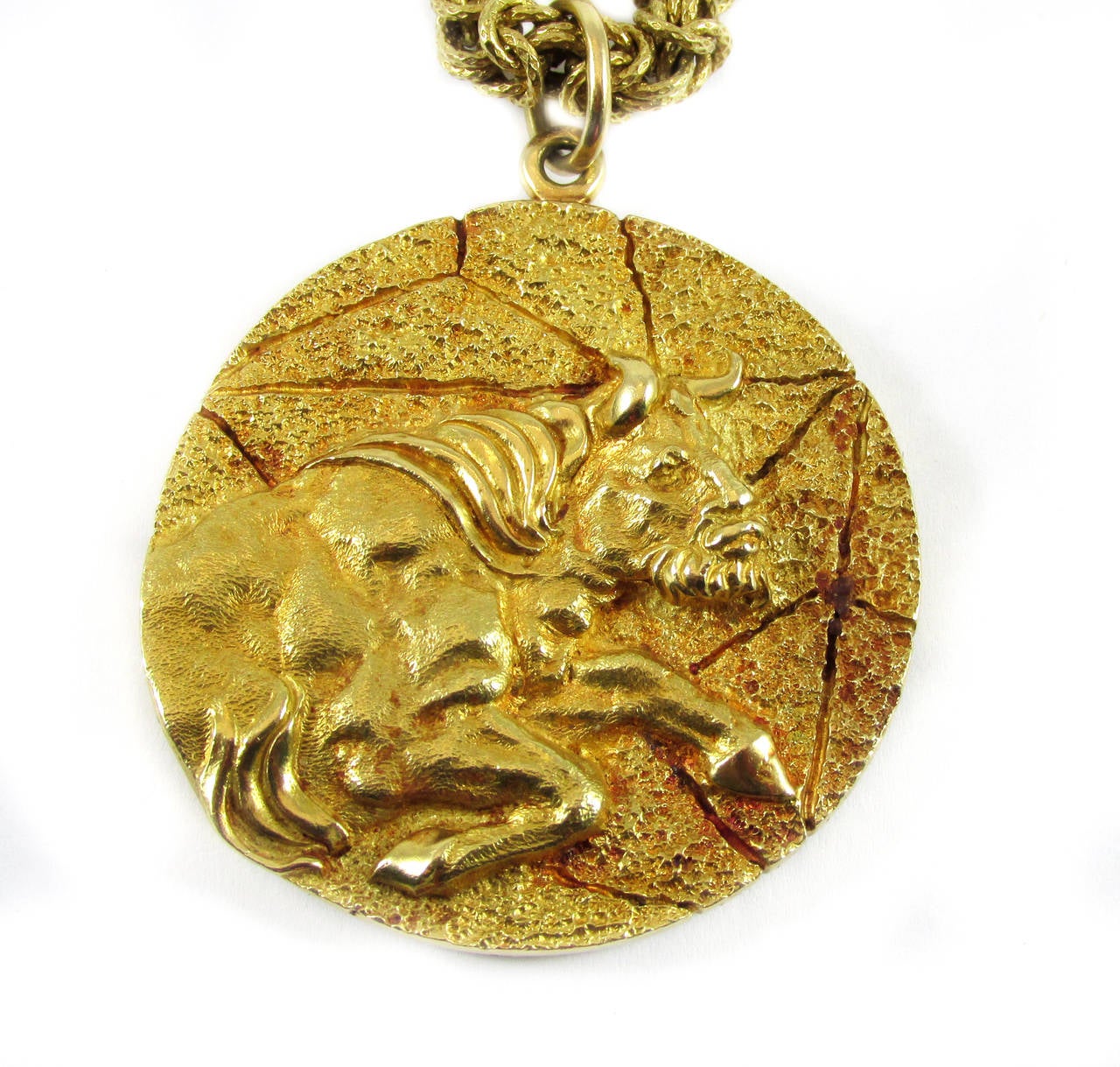 Tiffany & Co. 18 karat gold Taurus pendant necklace, thick rope chain,Taurus bull on one side and Taurus zodiac symbol on reverse side of the pendant, stamped Tiffany Italy 18 K on pendant, stamped 18K 750 and numbered 218 AL on clasp of necklace.