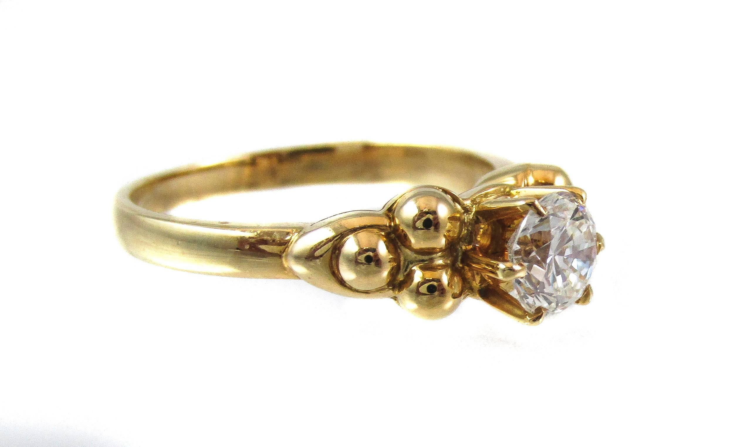 This “new-old stock” ( previously never worn) Fred Paris 18 karat yellow gold diamond solitaire is a true catch for someone looking for a chic and elegant look with a nice bright white center stone. Three finely detailed and highly polished gold