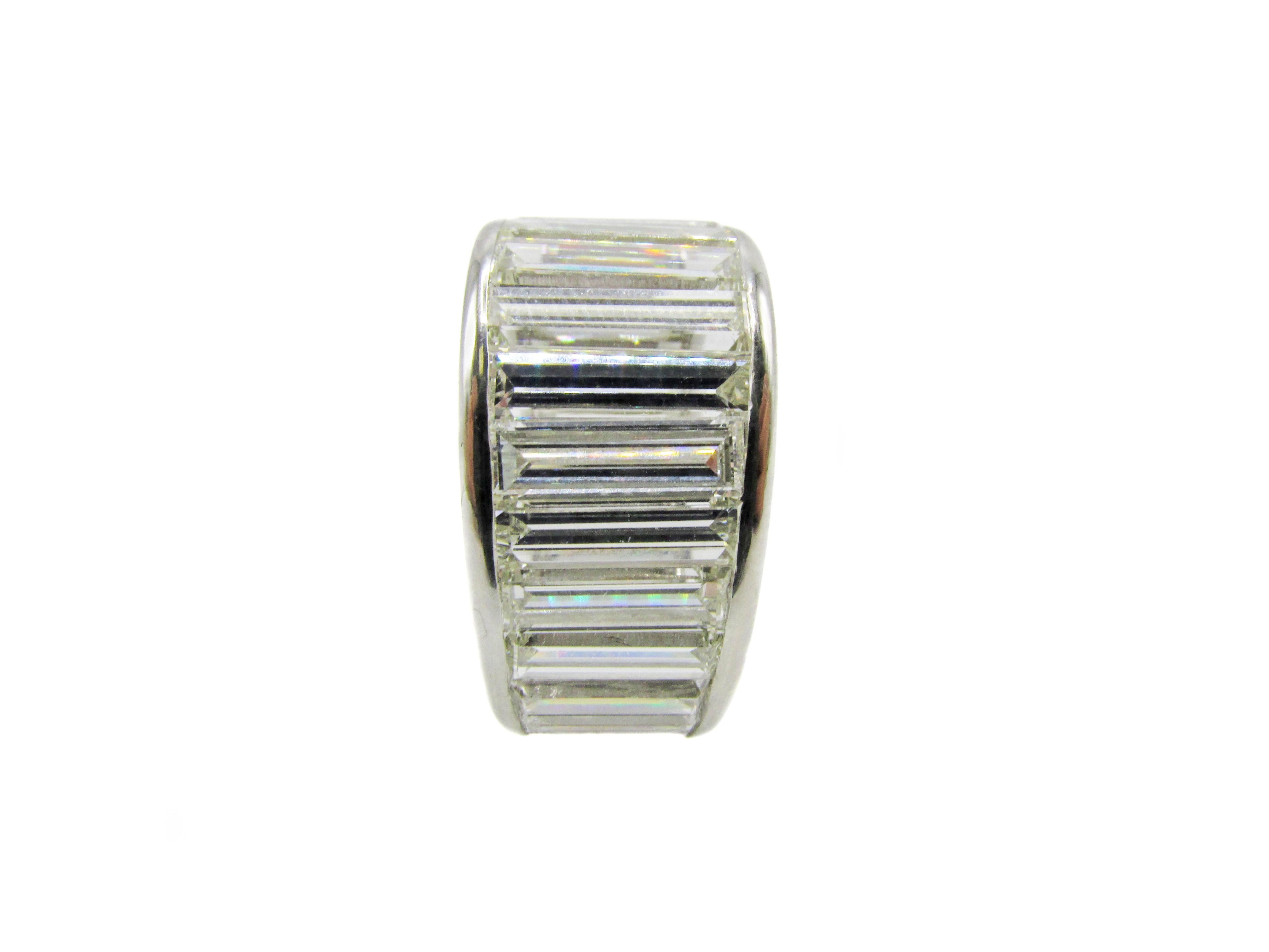 Unique platinum baguette diamond eternity band set with 26 bright white baguette cut diamonds with and approximate total weight of 12.50 carats. The average color of the baguettes is F-G and the clarity VVS-VS. The width of this band is 11.10 mm (