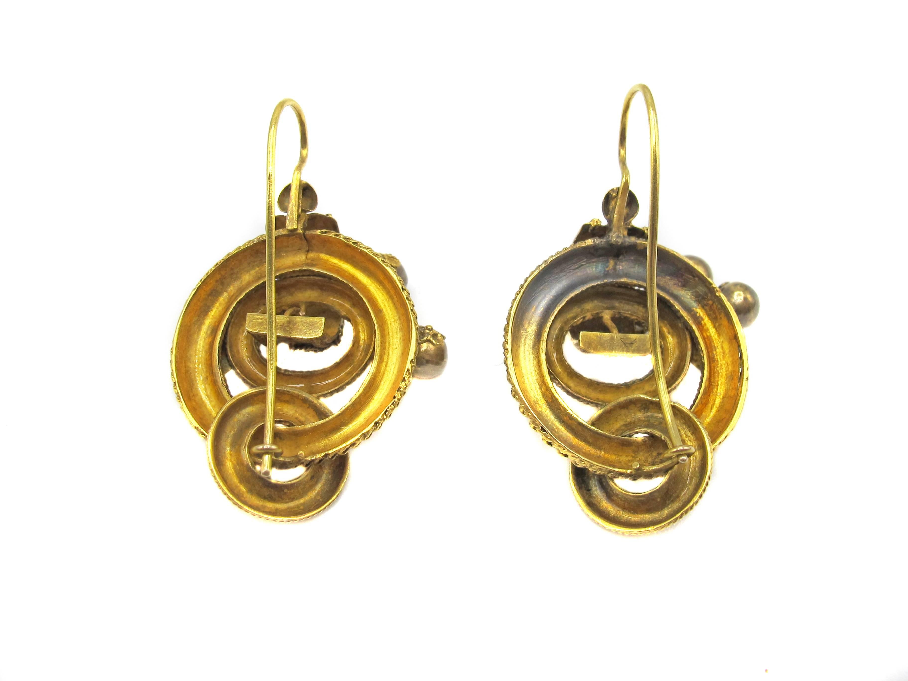 Beautiful 15 karat yellow gold Victorian ear pendants, skillfully handcrafted and designed out of 3 interlocking circles with detailed granular work on each of them. On the top of the outer ring, a leaf with fine detailed gold work showing it's