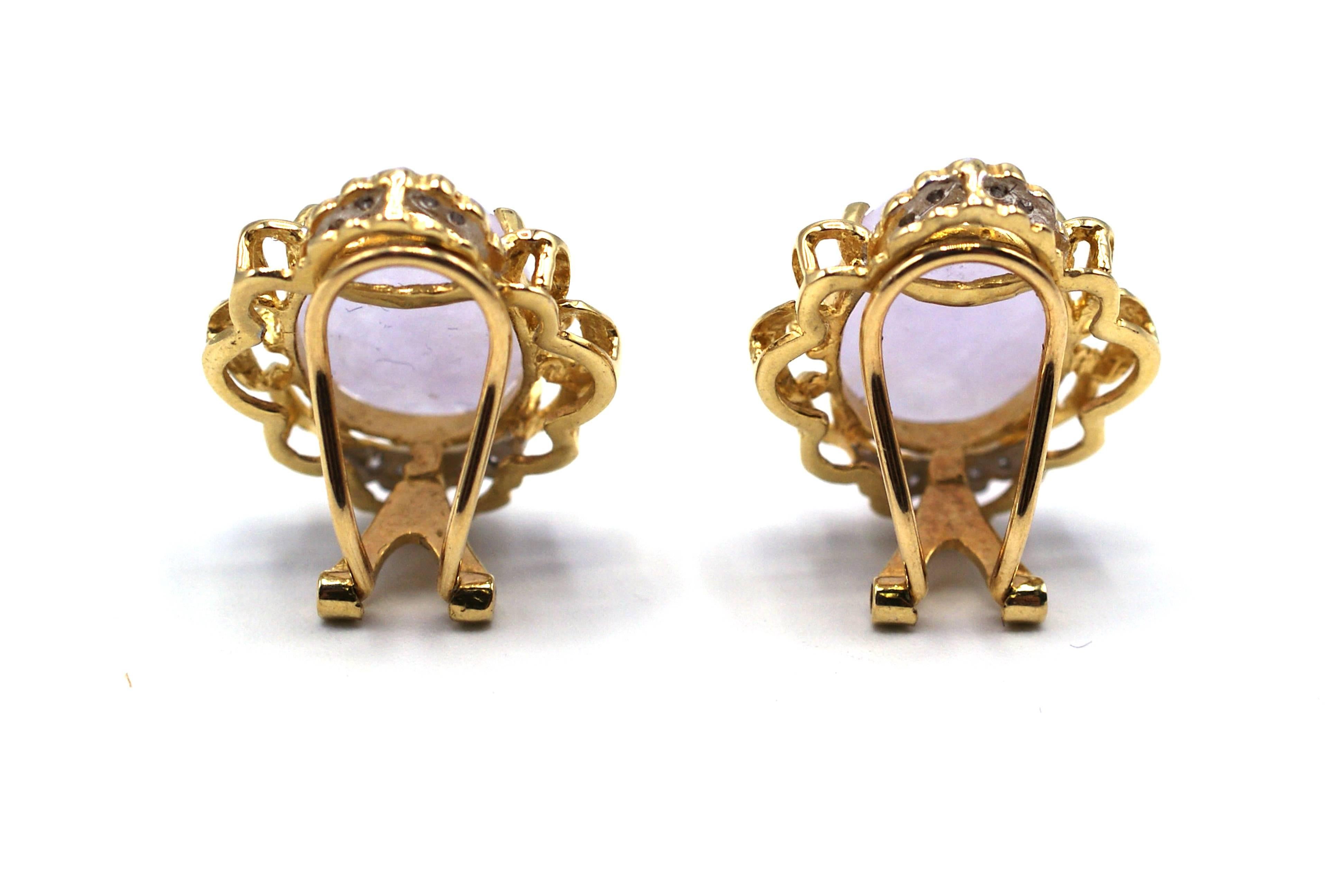 Beautiful lavender jade cabochons, perfectly matched in size and color are set in a yellow and white gold ornate mounting, with an omega clip back. The cabochons measure approximately 13.8 mm by 10.3 mm and are prong set with wave like gold work