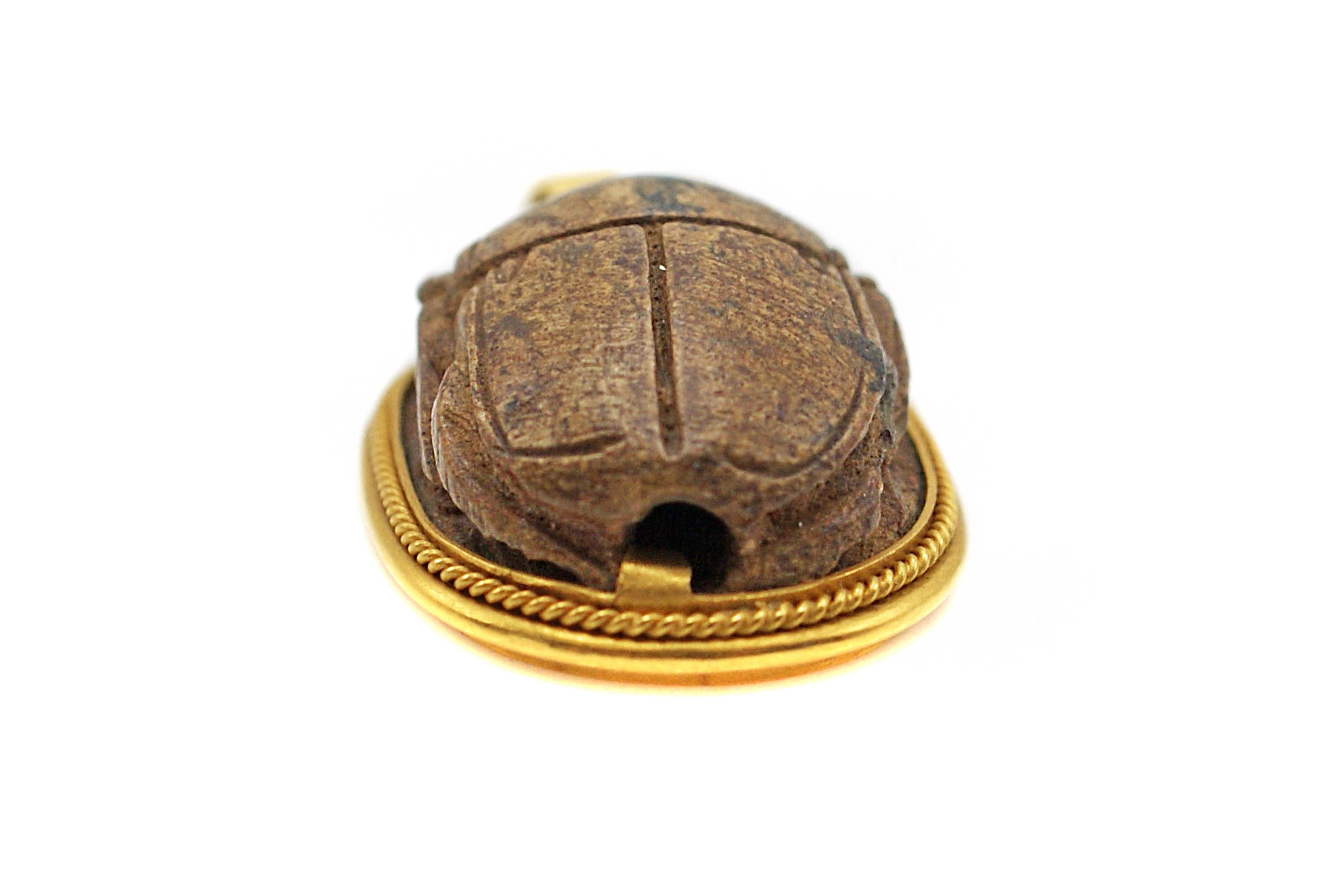 A beautiful antique wood carving depicting a scarab in the front and ancient symbols in the back, was inspired by the Egyptian Revival Period when new excavations were made in Egypt in the 19th century. The findings which were made public all over