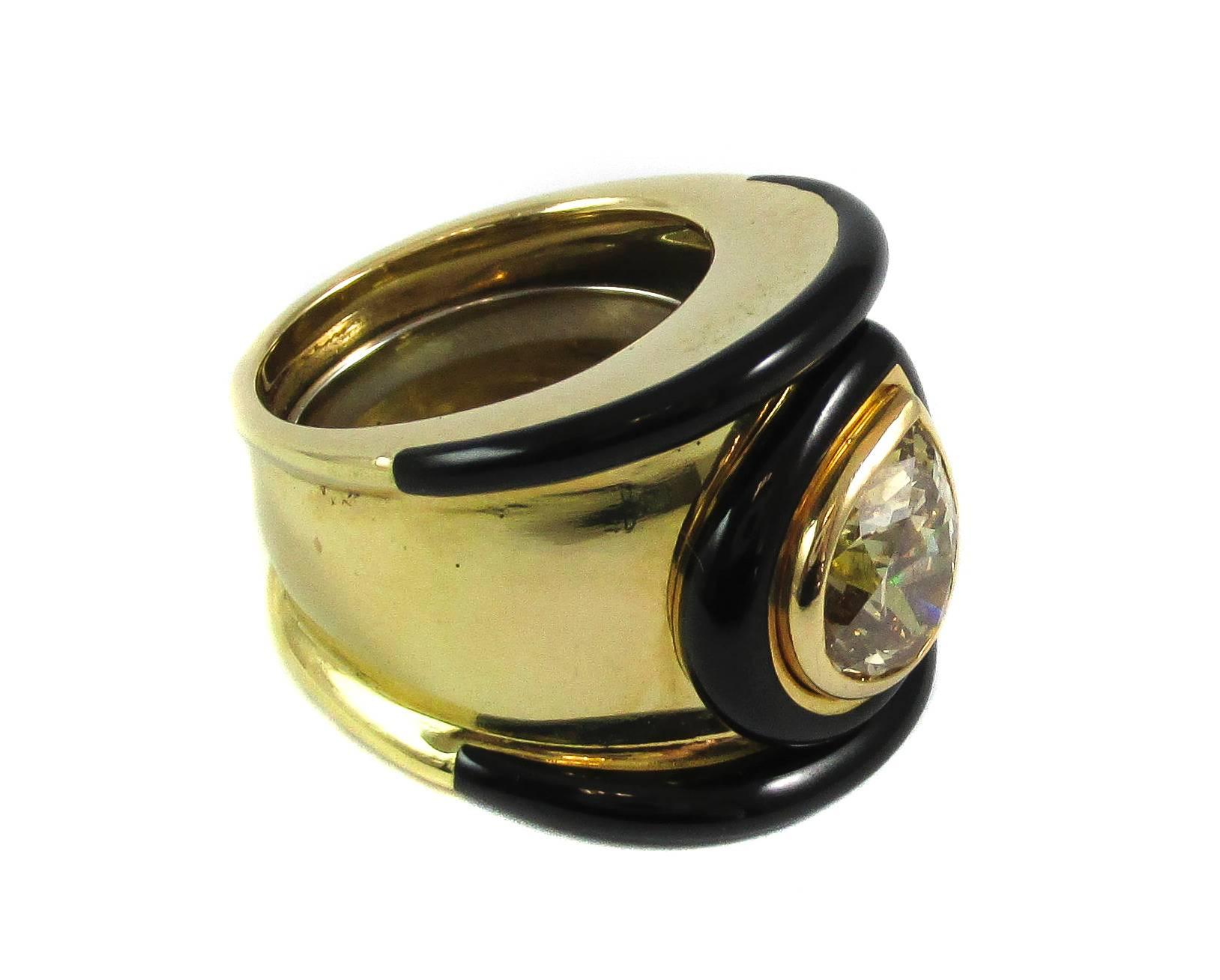 Extraordinary black enamel 18 Karat yellow gold and pear shape diamond ring, ca 1980. This “out of the box“ design, which David Webb is known for, features a lively cognac colored diamond set sideways in a gold bezel and accented by a bezel of black