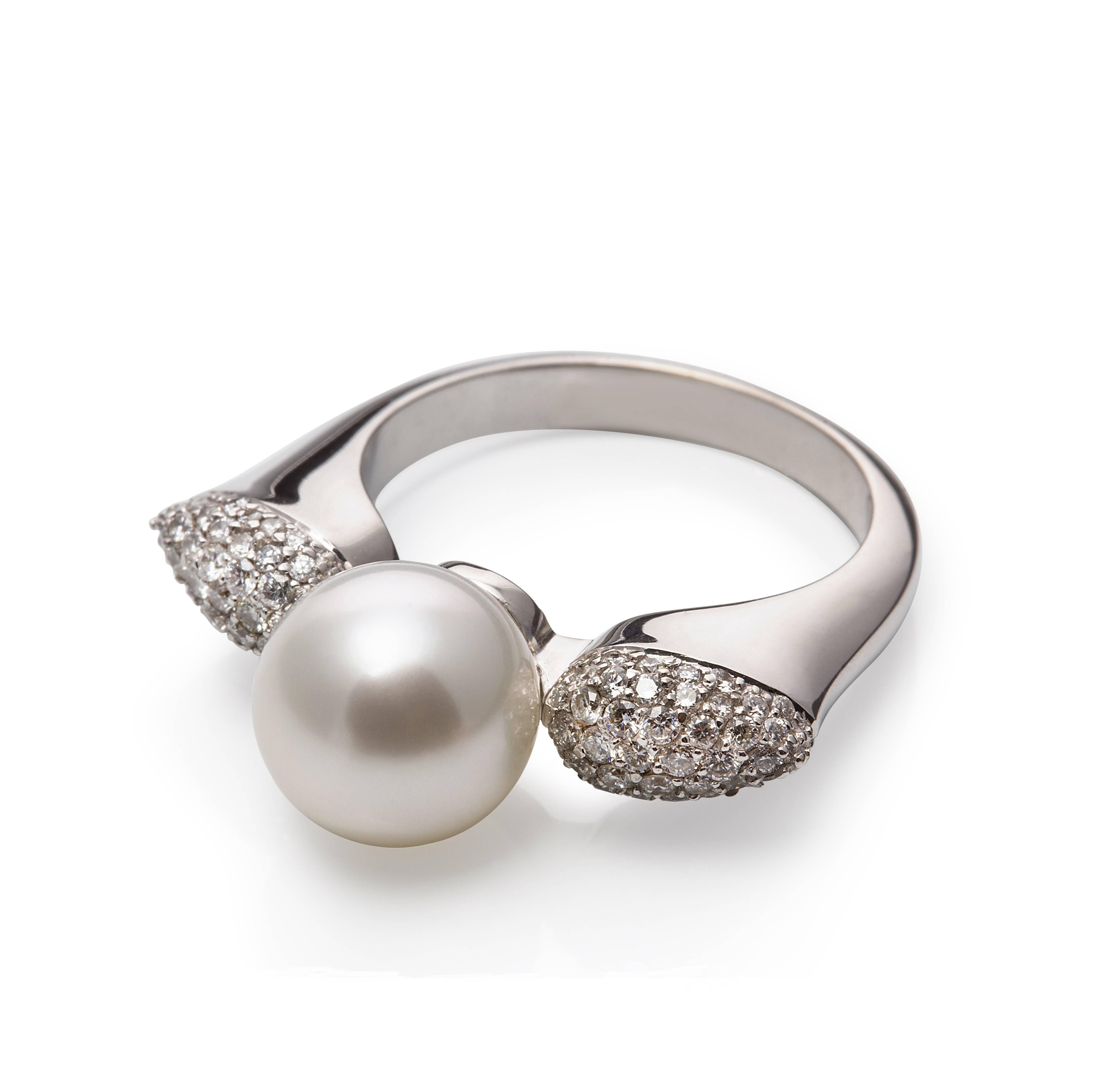 18ct white gold pave set side cushioned ring with 0.60ct diamonds with a centre 
0.37in/9-10mm white round high lustre exquisite South Sea pearl.

The curve of the shank gives comfort between the fingers and assists the shape to flare above the