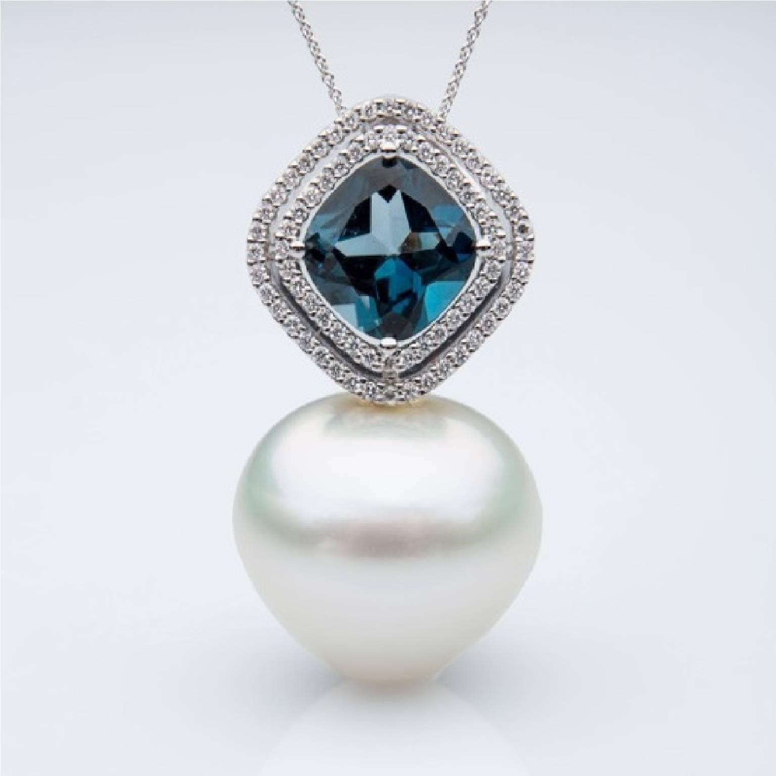 Stunning and bold London Topaz pendant, surrounded with 0.30 carat white diamonds.  

This pendant is perfectly balanced with an 18.2mm triangular shaped white, grade 1, fine nacer, high luster, white pink color, Australian South Sea pearl. 

The