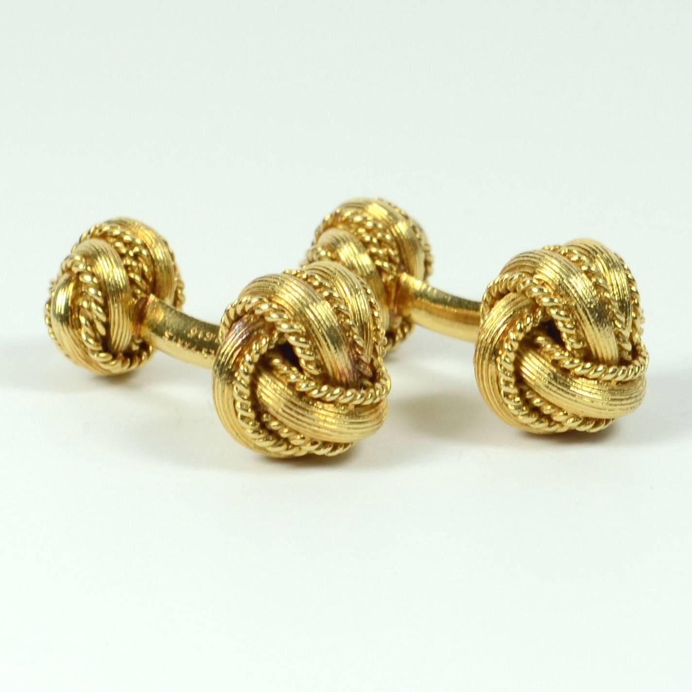 A pair of heavy 18 carat gold double knot cufflinks made by Georges L'Enfant for Hermes Paris. Each knot is handcrafted from ridged gold with twisted gold edges and is set to a curved bar.  

The cufflinks are signed Hermes Paris and numbered 57616.