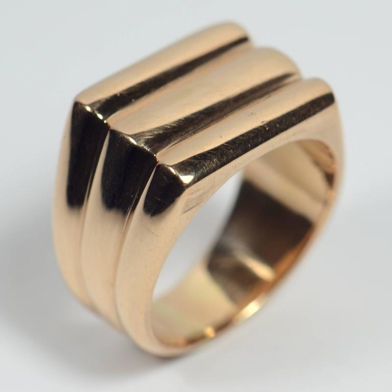A heavy French 18 carat rose gold ring designed as three curved ridges encircling the finger, with a flattened top.  This ring has been handmade rather than cast from a mould, and the quality of the manufacture is evident in every sleek line and