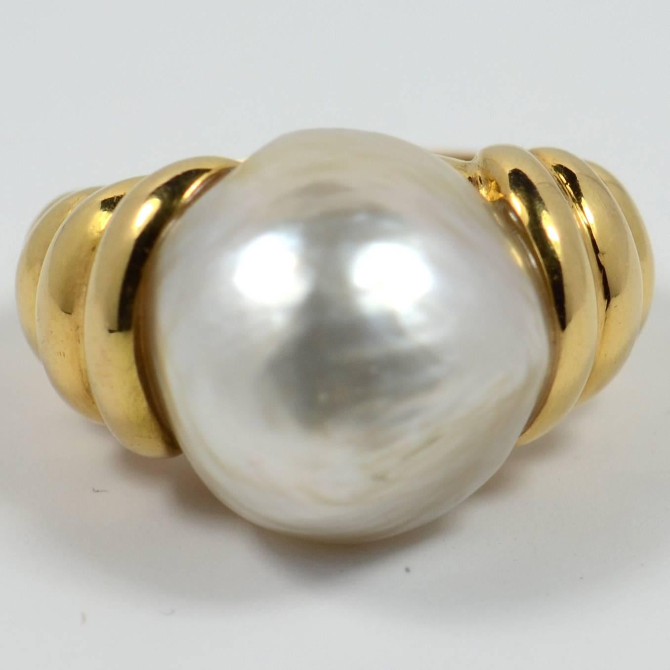 This gorgeous ring by Christine Escher has a voluptuous form with swirls of 18 carat yellow gold rising to meet a large, slightly baroque mabé pearl with tones of gold to its whiteness.  The pearl measures 15.5mm x 16mm x 10.5mm. 

The ring is