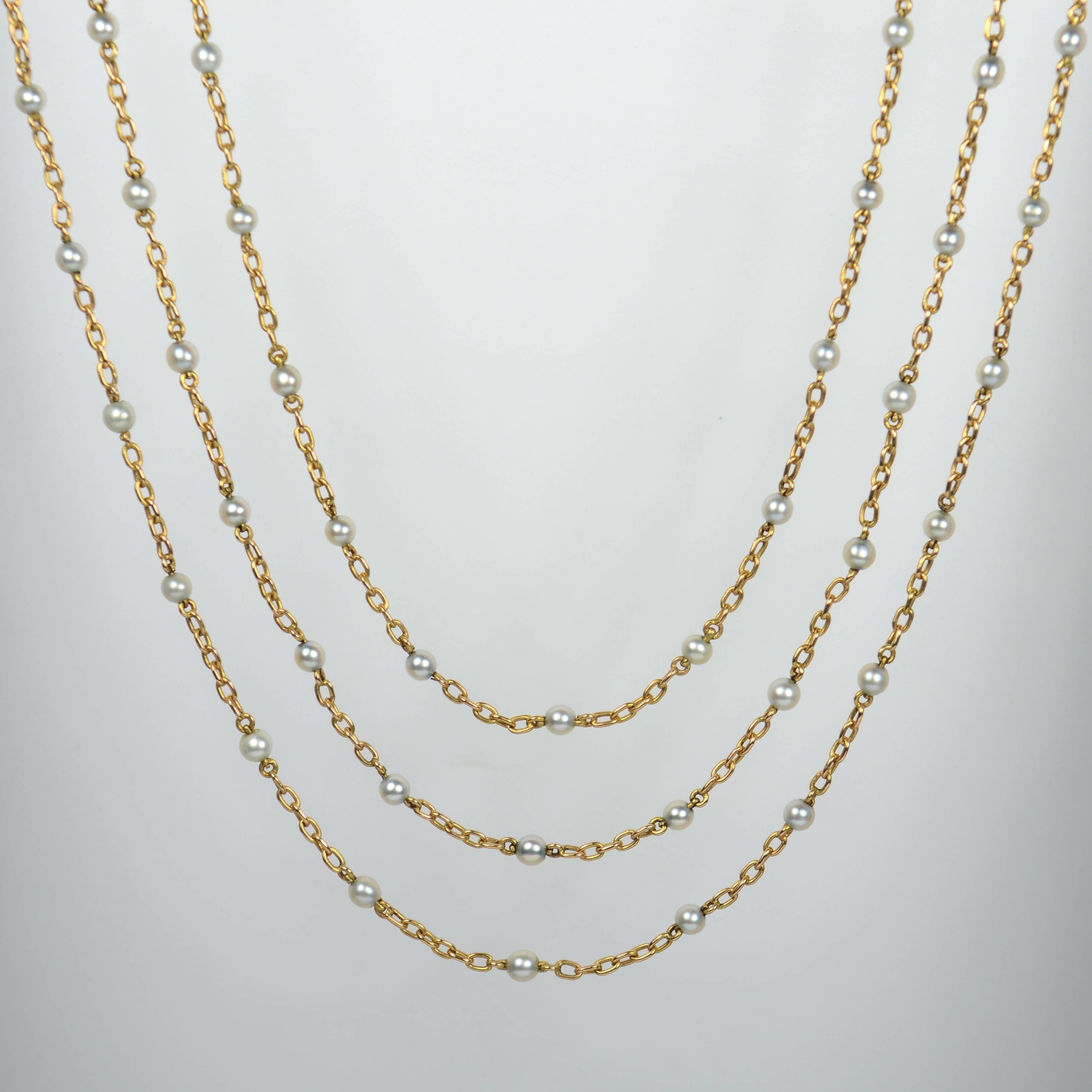 A fabulously long French chain necklace in 18 carat gold set with 88 round, lustrous, natural white pearls.

This gold and pearl necklace measures a whopping 161cm in length (53.5 inches) and may be worn a number of times around the neck, or wrapped