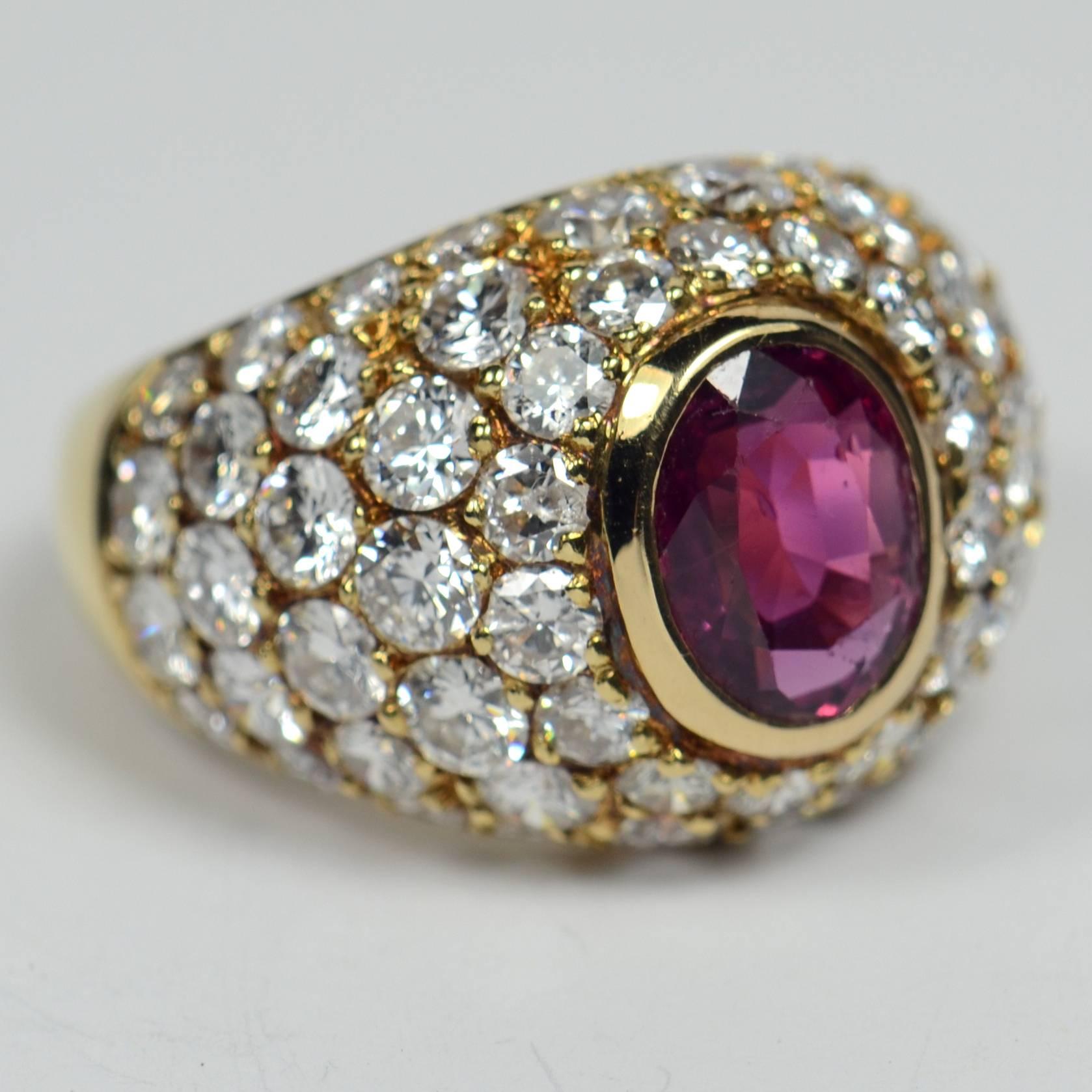 An 18 carat yellow gold French bombe ring centring an oval unheated ruby surrounded by pave-set round brilliant cut diamonds.

The natural, untreated ruby is estimated to weigh 1.60 carats, and we believe it to have come from Madagascar. The 58