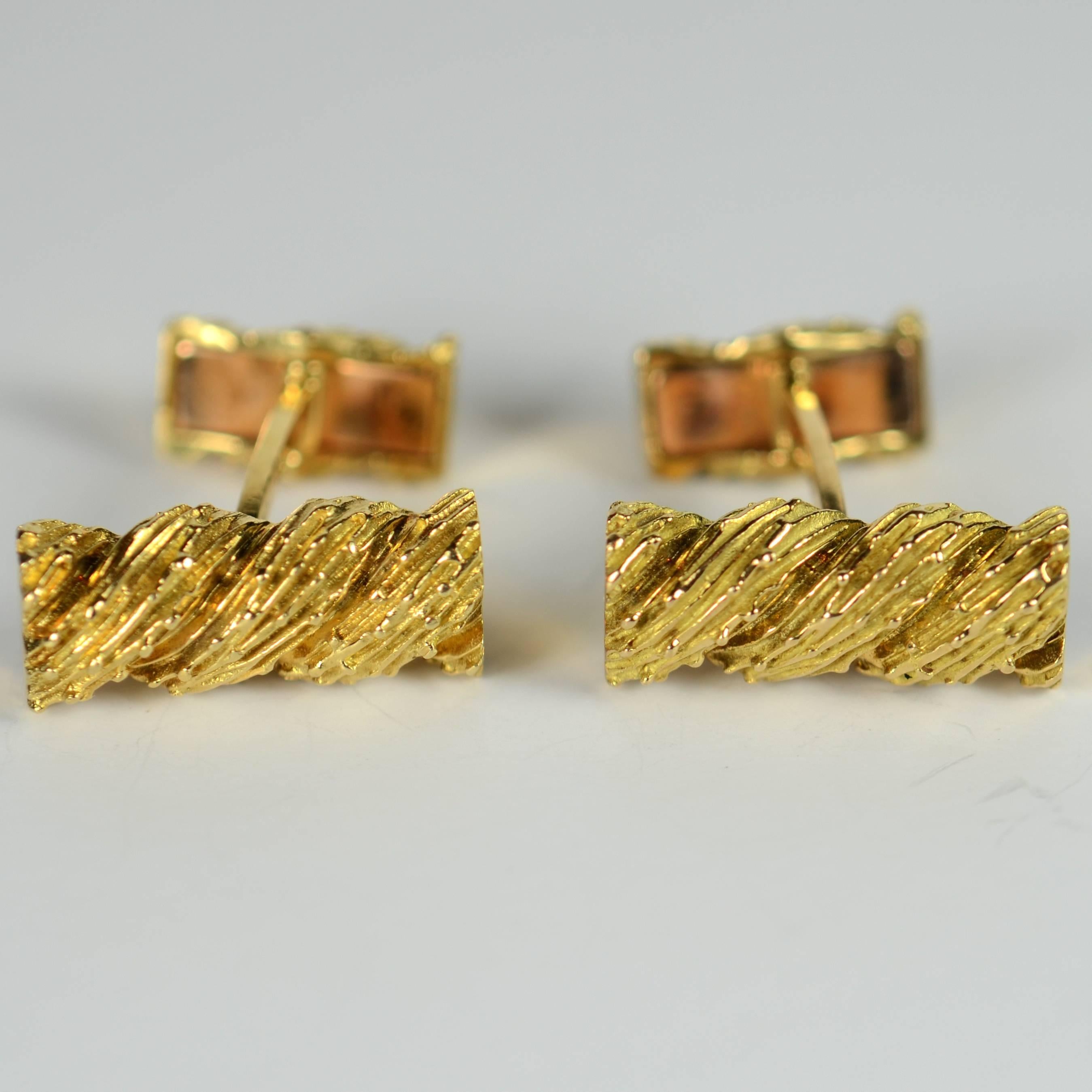 A smart pair of cufflinks in 18 carat gold with twisted and textured rope detail by Van Cleef et Arpels from the 1970s.  The hinged backs of the cufflinks are in excellent working order and secure tightly. 

The cufflinks are stamped with the