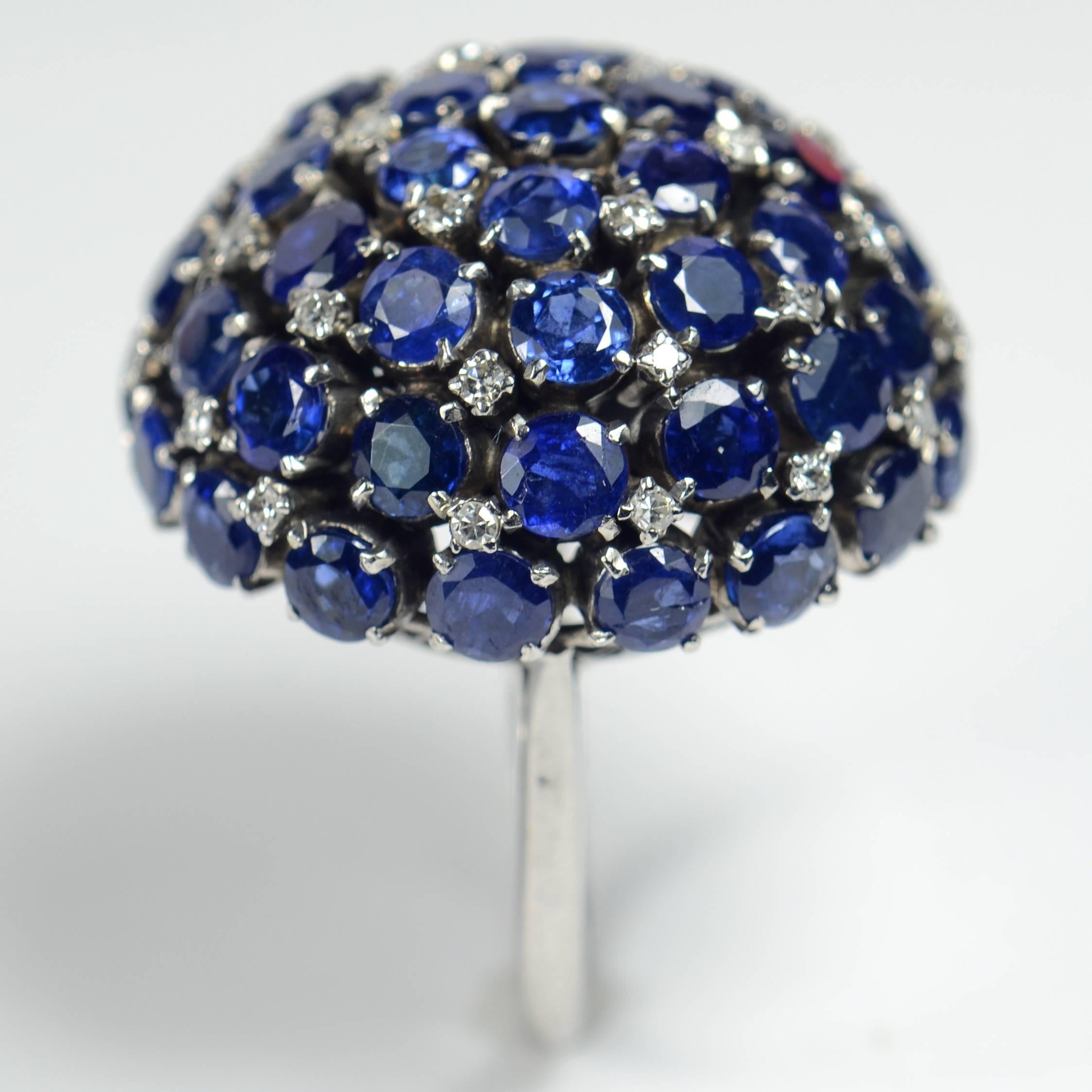 This fabulous cocktail ring is set with 50 sapphires of Thai origin weighing an approximate total of 17 carats, interspersed with 31 single-cut and brilliant cut diamonds with a total approximate weight of 0.40 carats.  

The ring is set in a bold