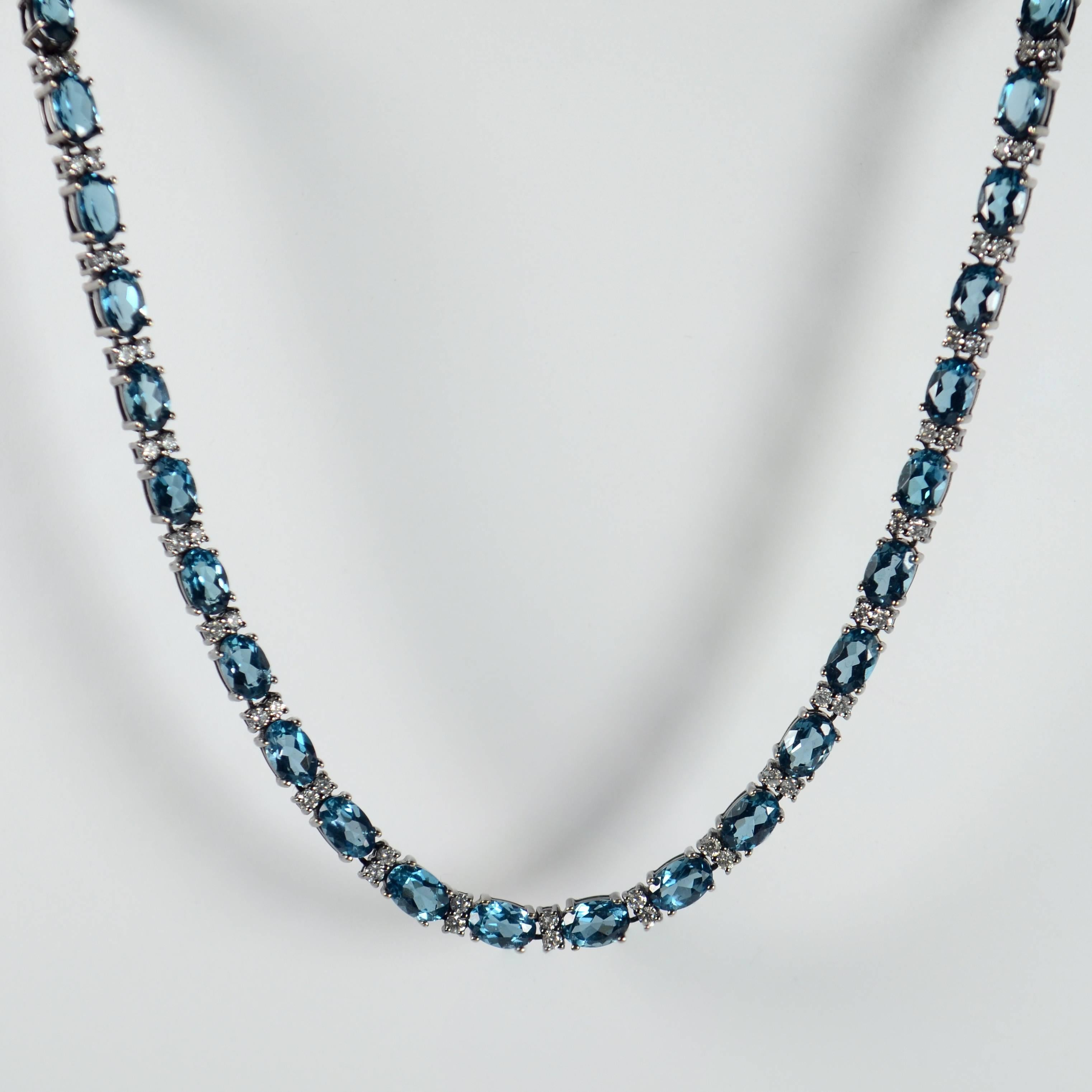 A sparklingly smart necklace in blackened gold set with 50 oval brilliant-cut blue topaz, each interspaced by 2 brilliant-cut diamonds (100 in total). The gemstones are mounted in blackened white gold for a contemporary chic feel to this glittering