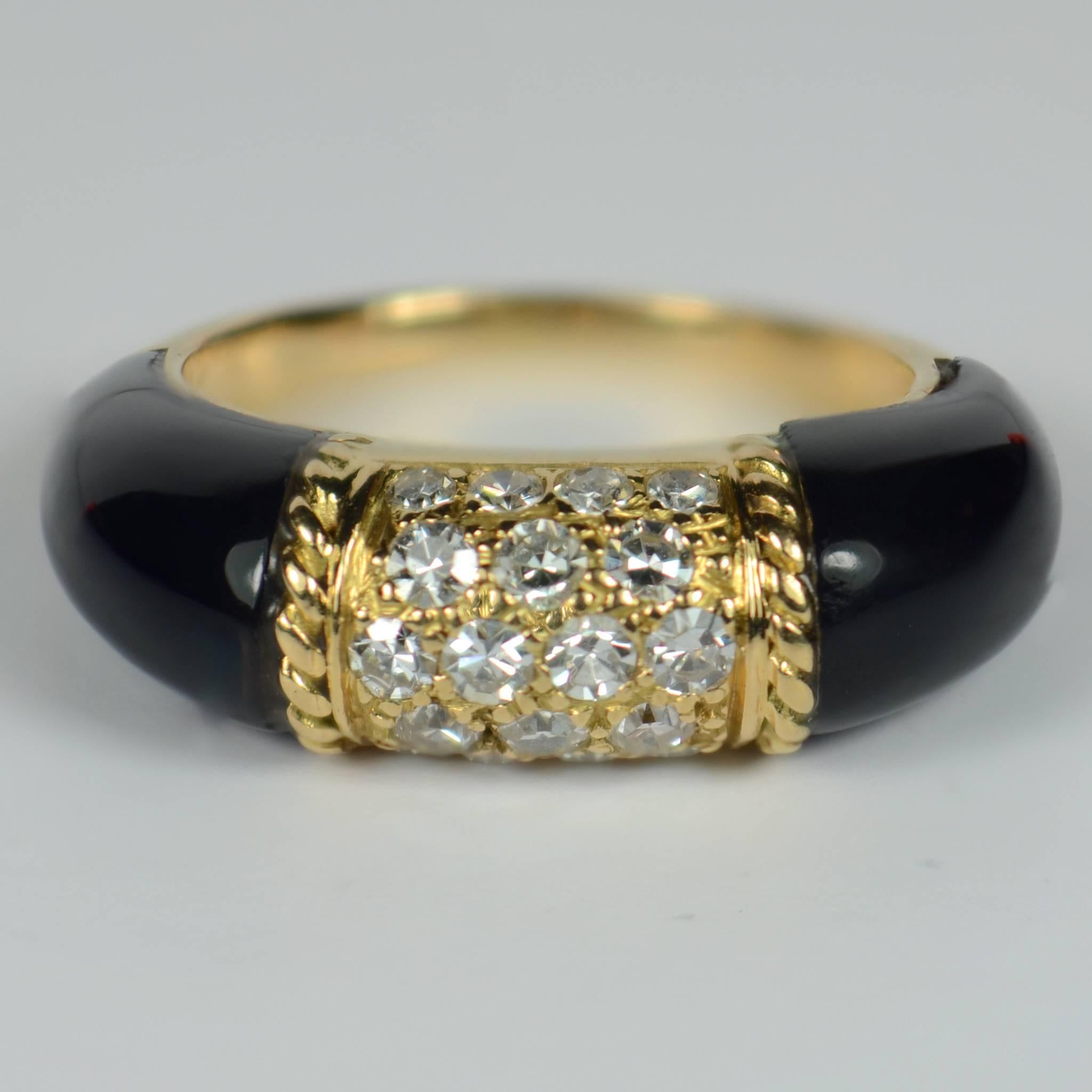A French 18 carat yellow gold ring set with 18 round single-cut diamonds within gold ropework borders, flanked by black onyx shoulders. This ring design was created by Van Cleef & Arpels and was known as the ‘Philippine’ ring. Although this ring