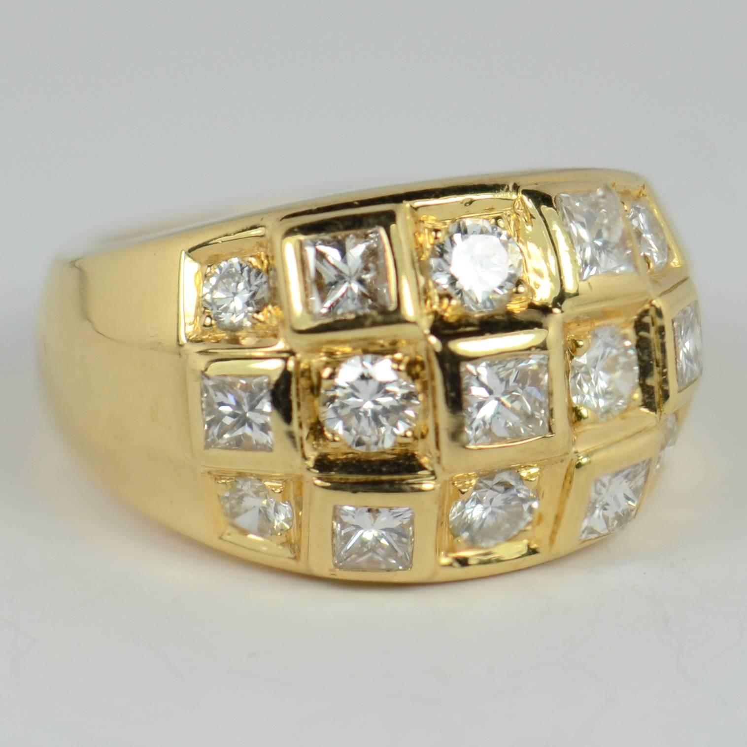An 18 carat gold dome ring set in checkerboard fashion with 7 collet-set princess-cut diamonds and 8 round brilliant cut diamonds weighing an estimated total of 2 carats.  

The head of the ring meets the shoulders in a gently geometric form