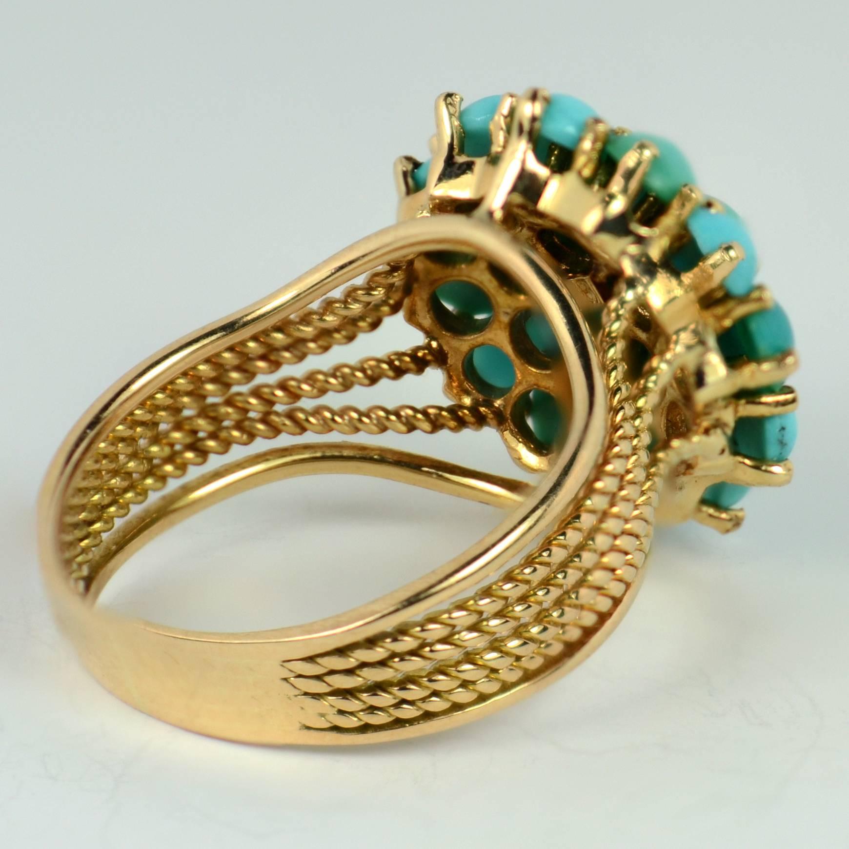 A simple and attractive 18 karat gold ring set with 19 cabochon turquoise to a smooth dome.  The shank of the ring has twisted and smooth gold wires to give textural interest.

Marked K18 for 18 karat gold.

Ring size 8 (US), P.5 (UK).