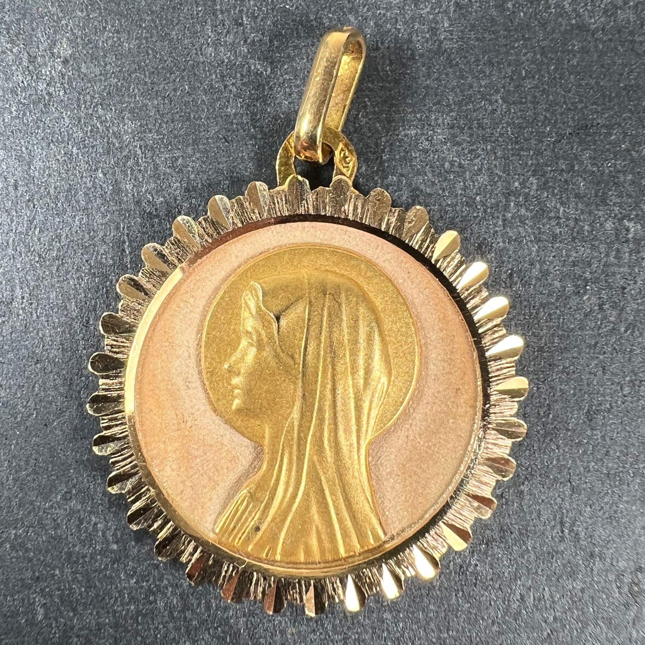 A French 18 karat (18K) yellow gold pendant designed as a round medal depicting the Virgin Mary against a rose gold sunburst ground. Stamped with the eagle’s head for French manufacture and 18 karat gold, with maker’s mark for Perroud.

Dimensions: