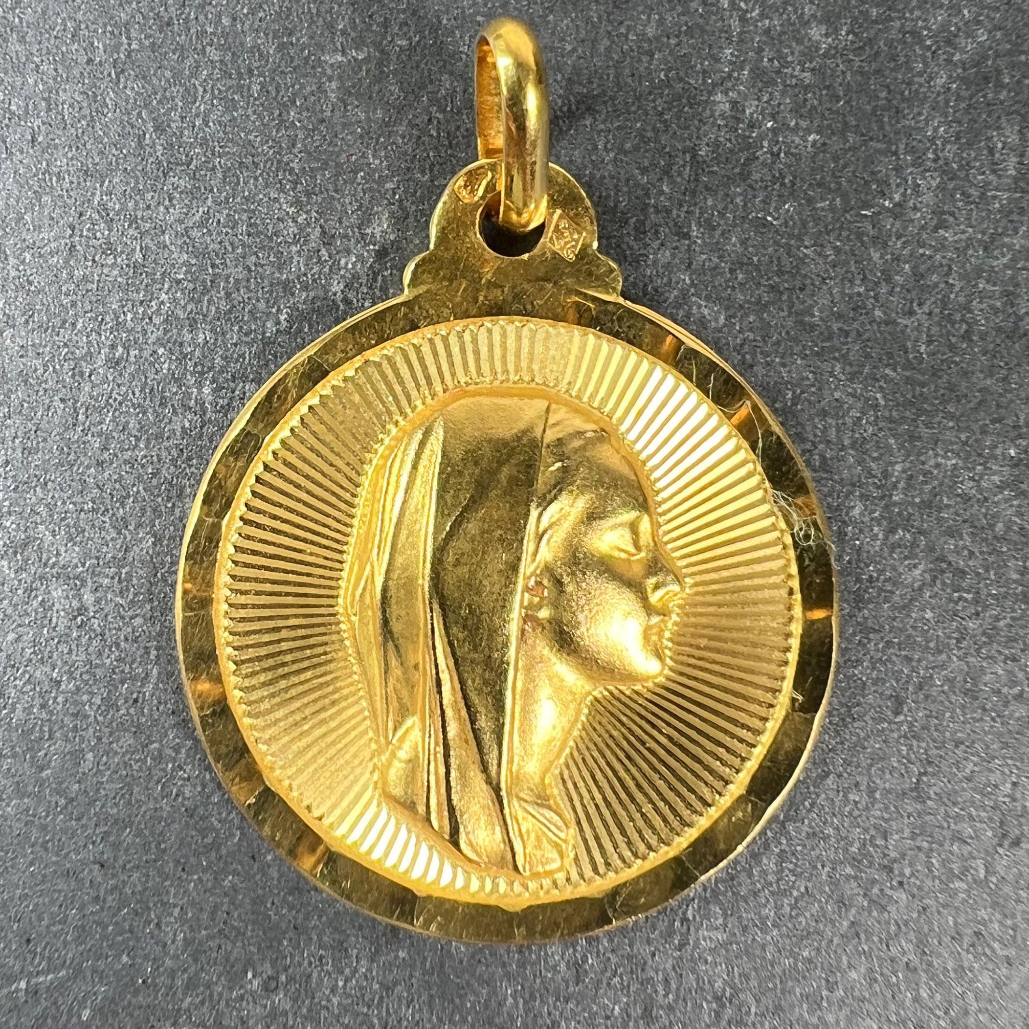 A vintage French 18 karat (18K) yellow gold pendant designed as a medal depicting the Virgin Mary within a sunburst. Stamped with the eagle’s head for French manufacture and 18 karat gold, with maker’s mark for Sonne of Lyon.

Dimensions: 2.5 x 2.1