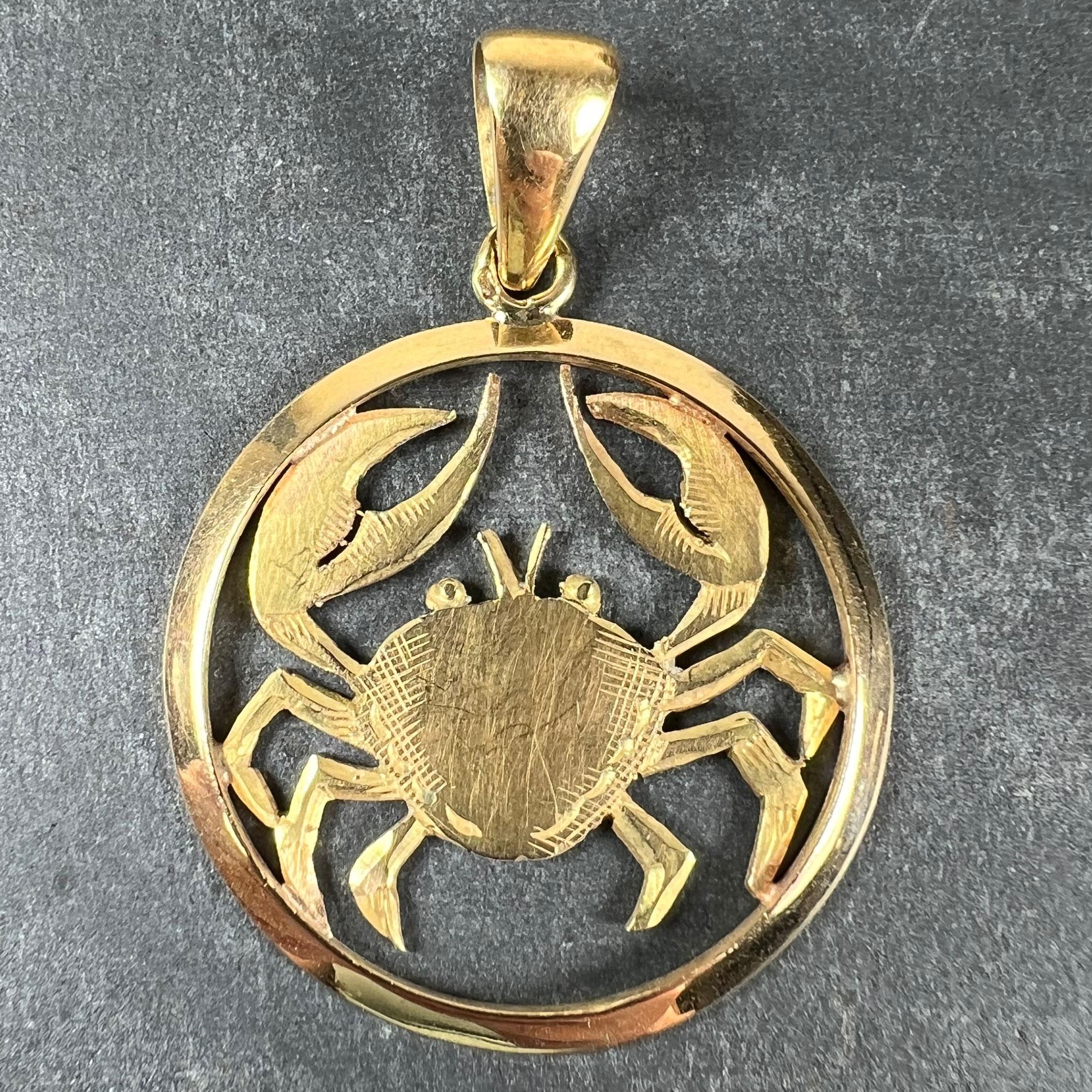 A large French 18 karat (18K) yellow gold charm pendant designed as the Zodiac sign of Cancer depicting a crab. Stamped with the eagle's head for French manufacture and 18 karat gold with an unknown maker’s mark.

Dimensions: 3.1 x 2.7 x 0.15 cm