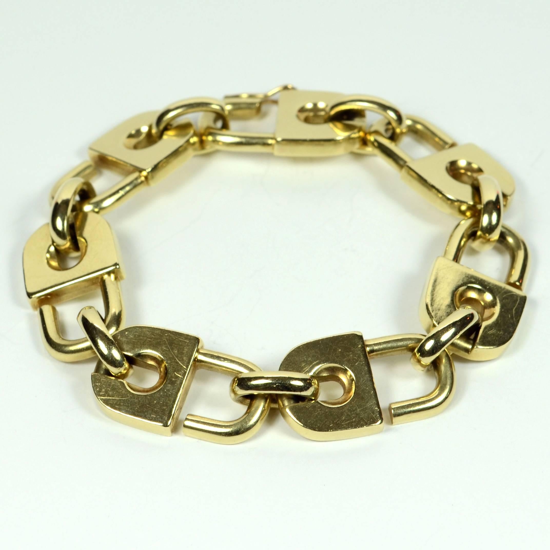 This incredibly cool gold bracelet is designed as seven padlocks locked together to form a continuous chain around the wrist, and is secured with a safety catch.  

Crafted in 14 carat gold, it is marked ‘Germany’, with an unknown makers mark.

Each