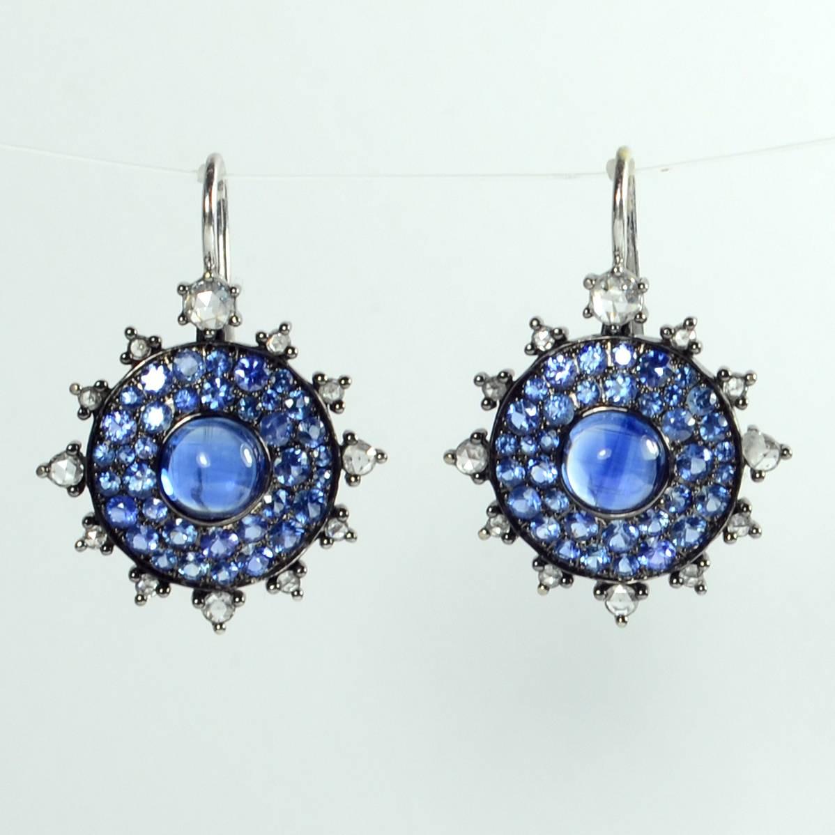 These “Bull’s Eye” earrings by contemporary New York designer Nam Cho feature deep blue cabochons of kyanite in a pave-set field of blue sapphires highlighted by rose cut diamonds and suspended on wire hooks.

The earrings reinterpret the classic