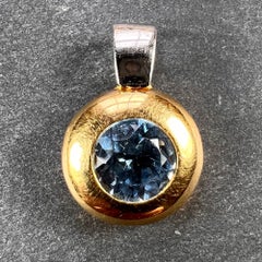 Ciondolo con spinello sintetico blu in oro giallo e bianco 18 carati