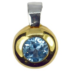 Ciondolo con spinello sintetico blu in oro giallo e bianco 18 carati